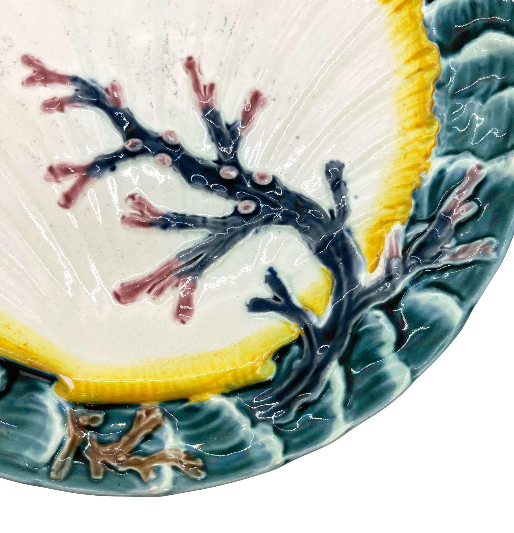 Wedgwood Majolica ocean plate, with a large central shell and seaweed, bordered with relief-molded waves, the reverse with impressed marks: 'WEDGWOOD,' and Wedgwood date letter, 'J' for 1881, with underglaze painted design number, '2949,' which