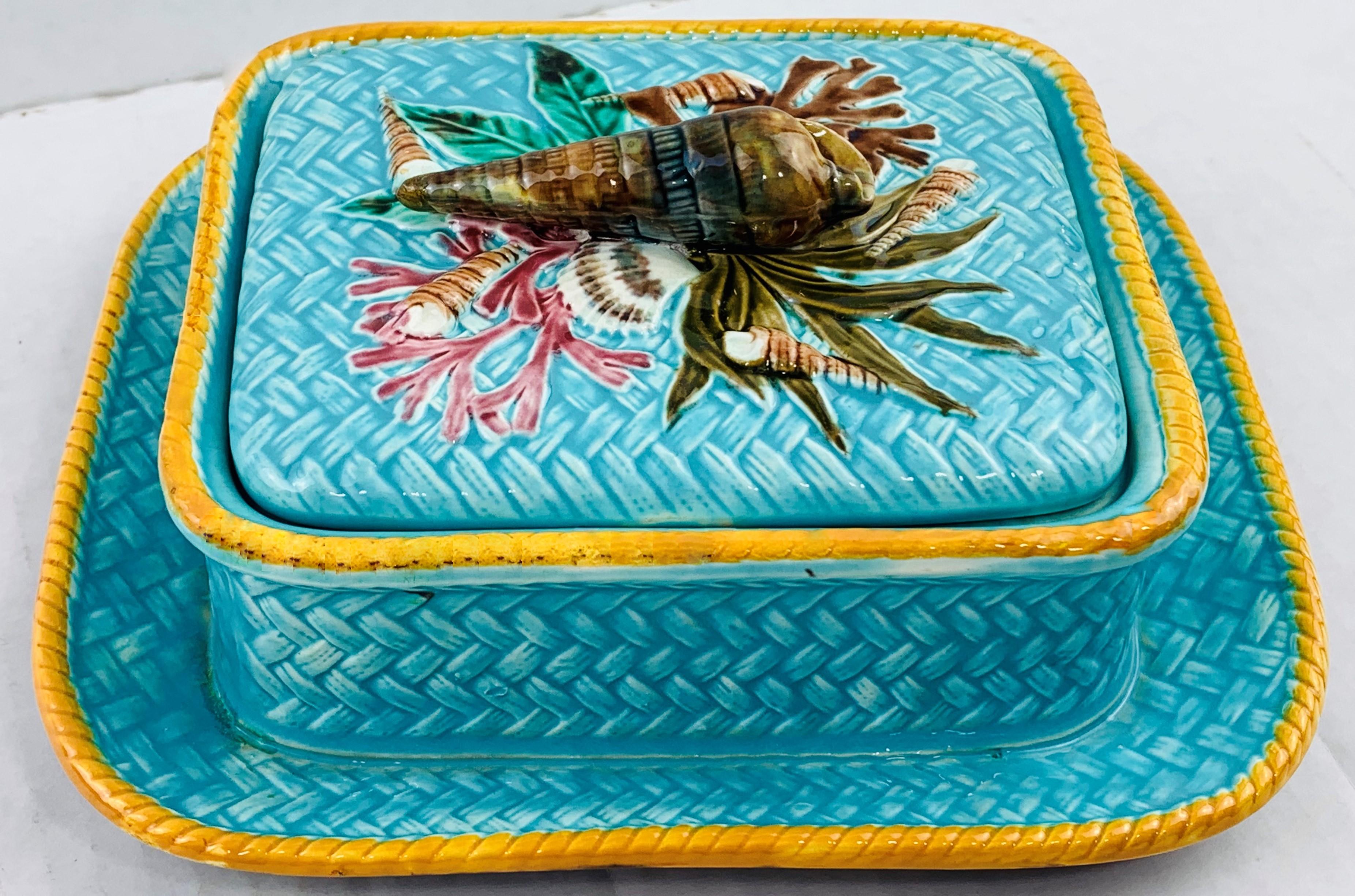 Wedgwood Majolica sardine box shell pattern on turquoise ground wicker, English, Dated 1877. Naturalistically modeled with seashells on a bed of seaweeds and coral, surmounted with a three- dimensional whelk shell forming the handle, on a simulated