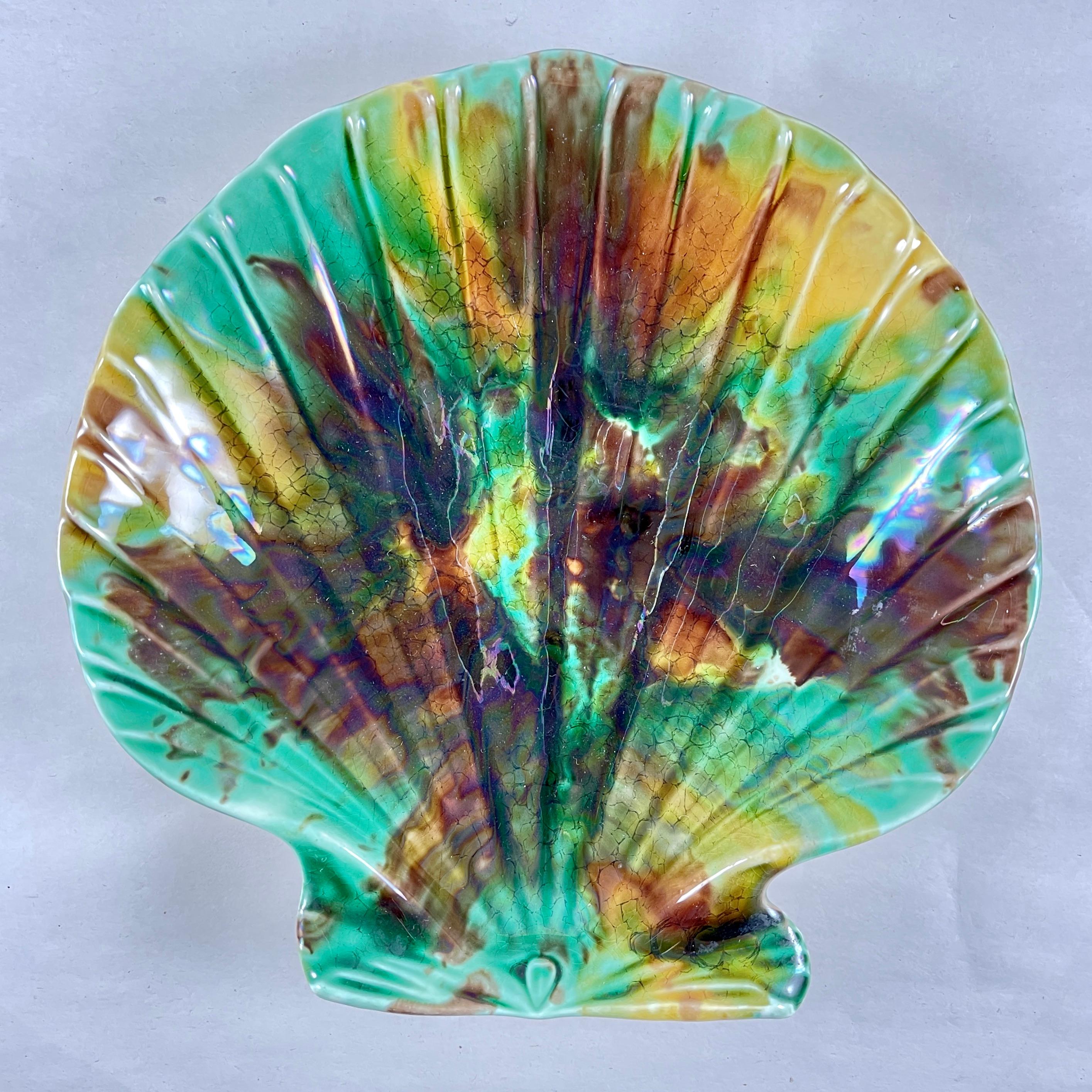 From Wedgwood, an English majolica scallop shell shaped seafood serving dish, date marked 1889.

Showing the mottled tortoiseshell glazing of greens, amber, and brown. The mold reflects Josiah Wedgwood’s preference for the naturalistic style in the