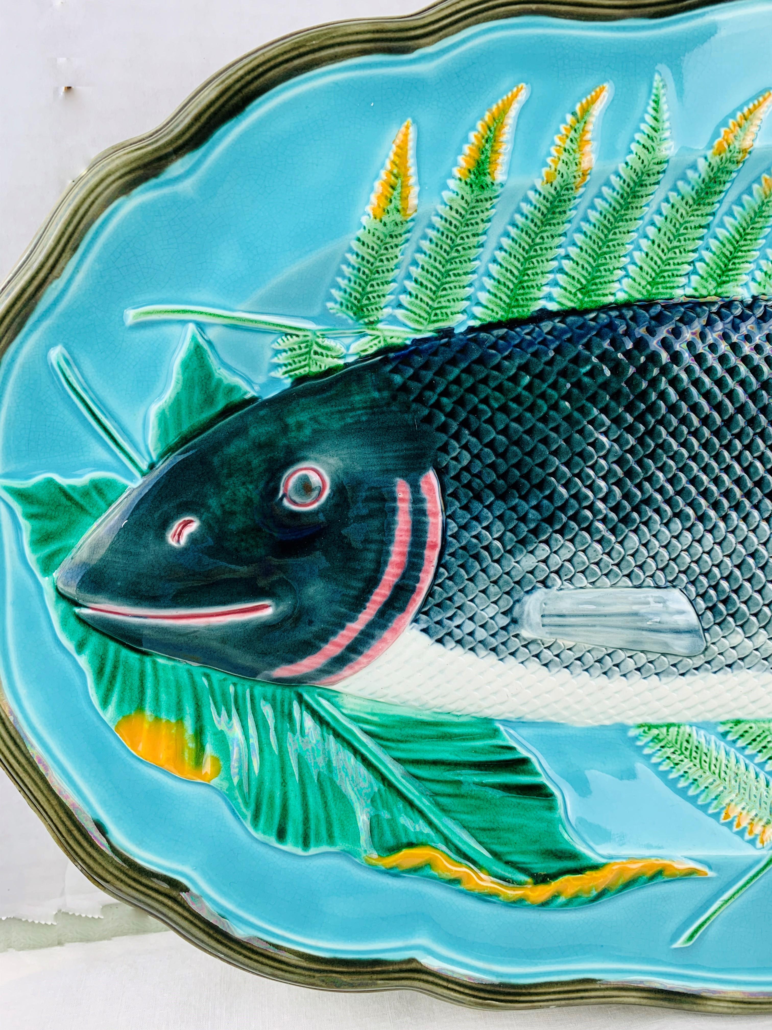 Wedgwood Majolica turquoise-ground salmon platter, English, 1878. Of shaped-oval form, molded in relief with a scaly salmon resting on a bed of leaves. Marks to reverse: impressed 'WEDGWOOD' with date cypher for October 1878, with painted pattern