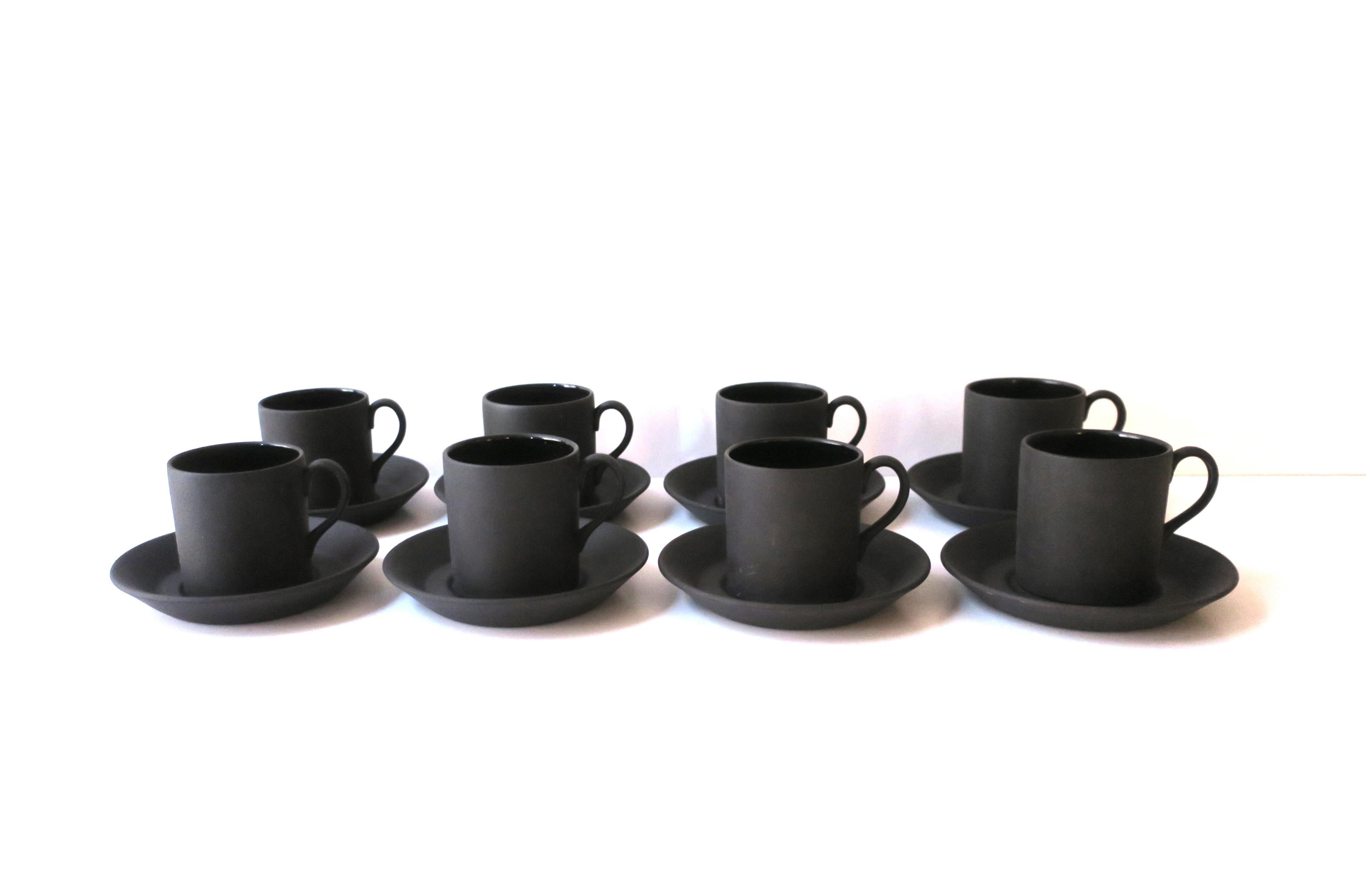 A beautiful and chic set of eight (8) English Wedgwood matte black basalt stoneware espresso coffee or tea demitasse cups and saucers, circa mid to late-20th century, England. Exterior of cup and saucer have a matte surface, interior of cup is