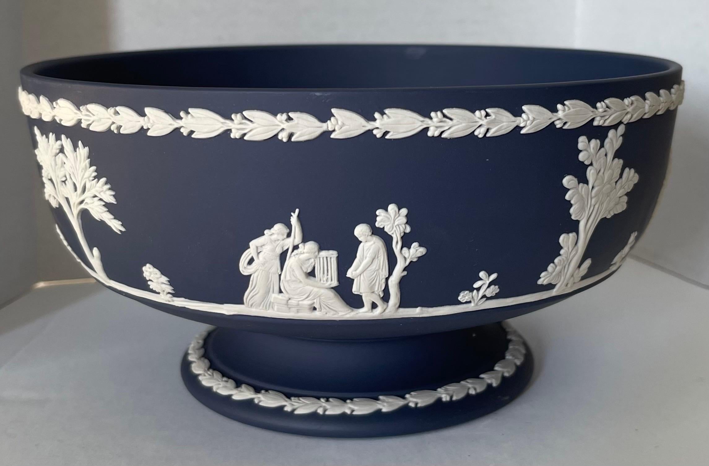 1970 Wedgwood jasperware footed bowl. Rare dark navy blue jasperware with all-over white neoclassical motif. Signed on the underside.