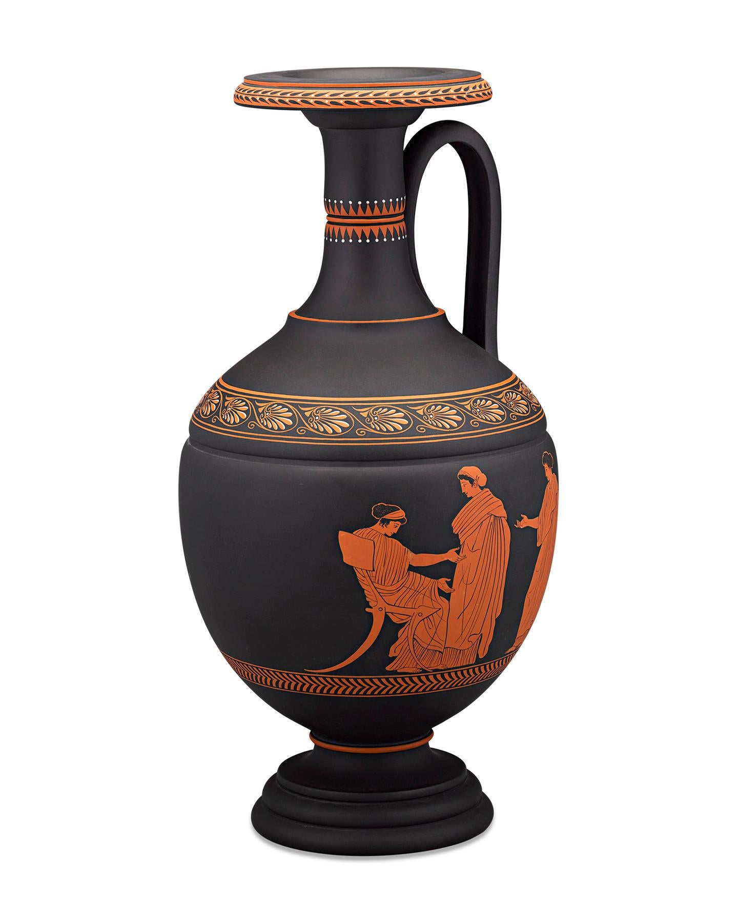 Crafted by Wedgwood, this stately Neoclassical amphora vase is comprised of black basalt — largely considered the pottery firm’s greatest innovation. Terra-cotta red and white encaustic enamel bands of anthemion, or palms, decorate the entire piece,