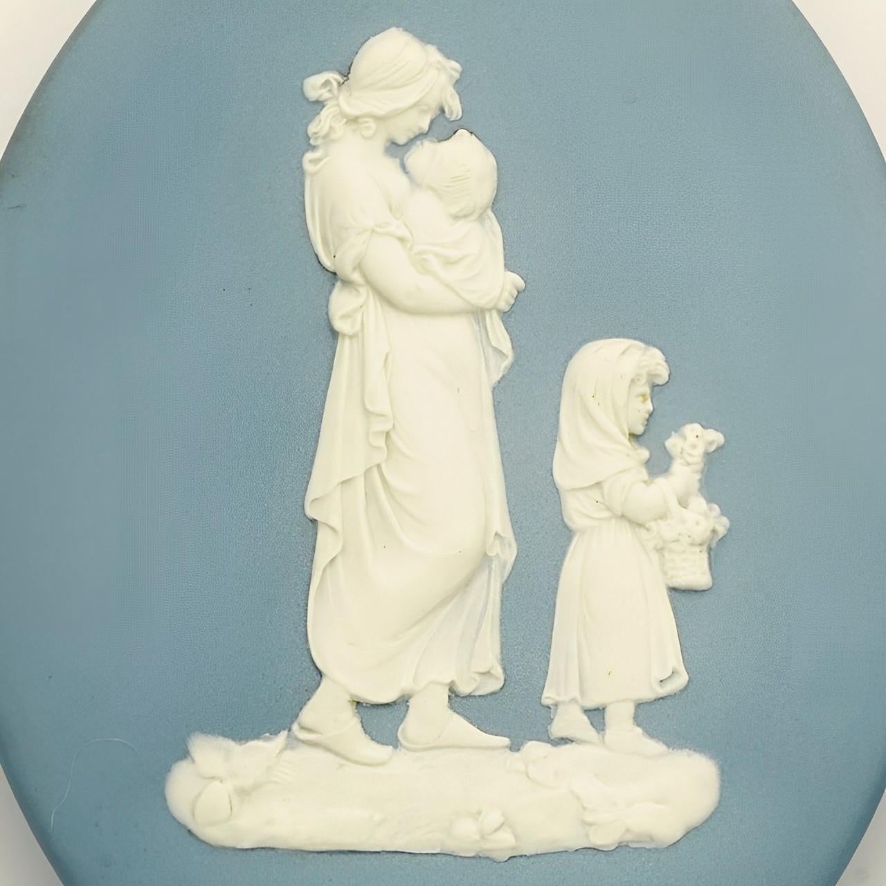 
Beautiful Wedgwood pair of blue and white jasperware pram plaques, featuring classical relief mother and child figures.  Measuring height 11.8 cm / 4.6 inches, width 9.2 cm / 3.6 inches, and depth 1.6 cm / .6 inch. We have given the plaques a light