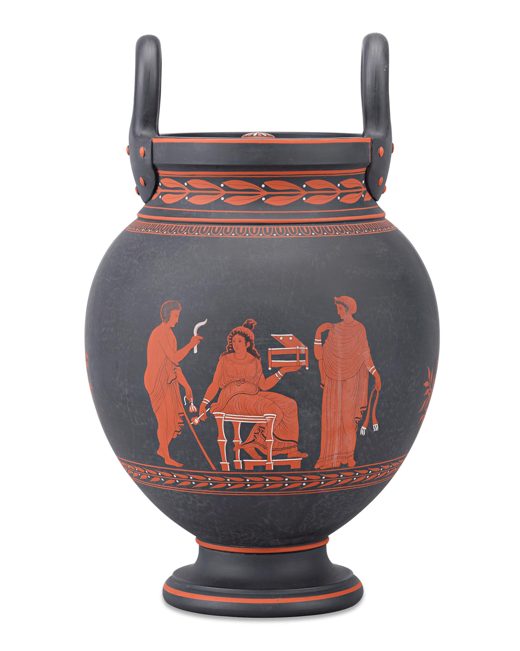Crafted by Wedgwood, this stately neoclassical volute krater vase is comprised of black basalt, largely considered the famed English firm’s greatest innovation. This beautiful vase is topped by a pierced lid, which allows the piece to be used as