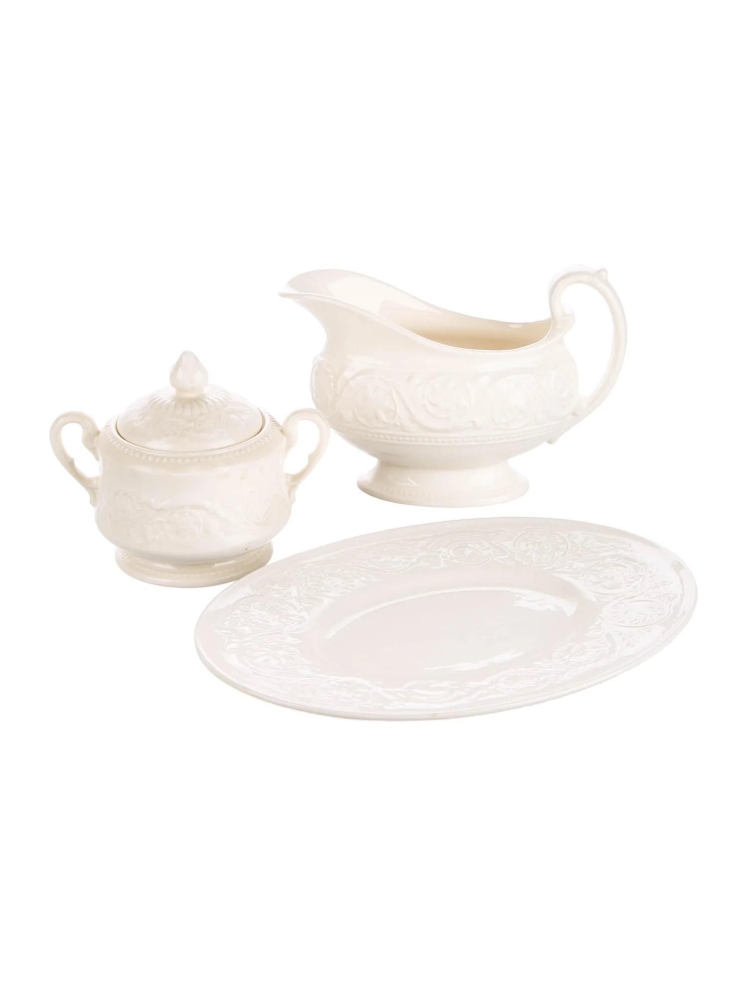 A 24 piece dinnerware set in the wedgwood Patrician pattern.

Features a tonal raised scroll motif throughout and brand stamp at undersides. 

Made in England, circa 1980.. This pattern was originally produced from 1927 to 1986.

Includes the