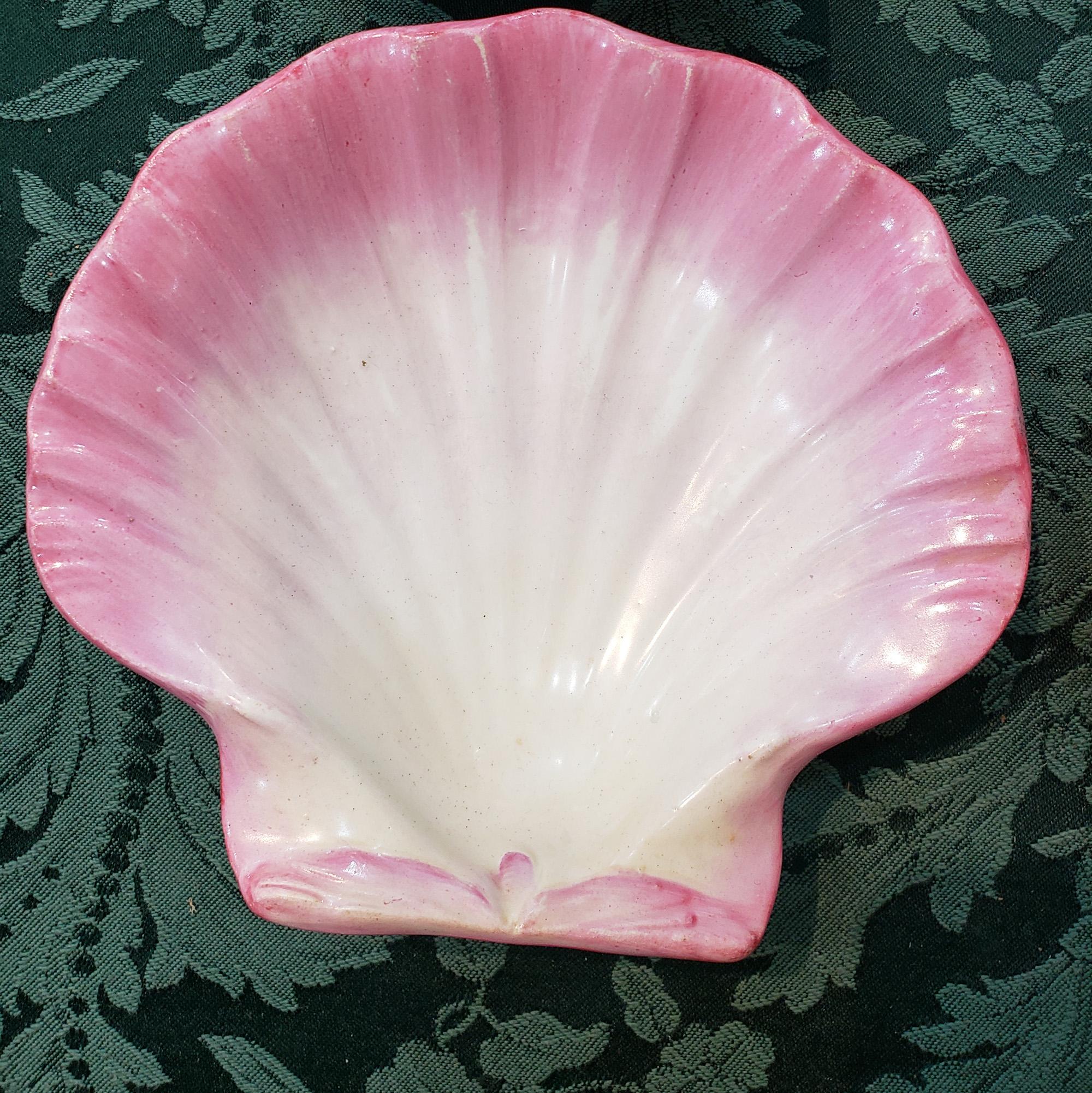 Wedgwood pottery pink scallop shell dishes,
Set of four, 
Pattern no. 7035
Circa 1866-80

The pair of wedgwood pearlware dishes are formed in the shape of a scallop shell in tones of pink and yellow.

Mark: upper case wedgwood; one impressed