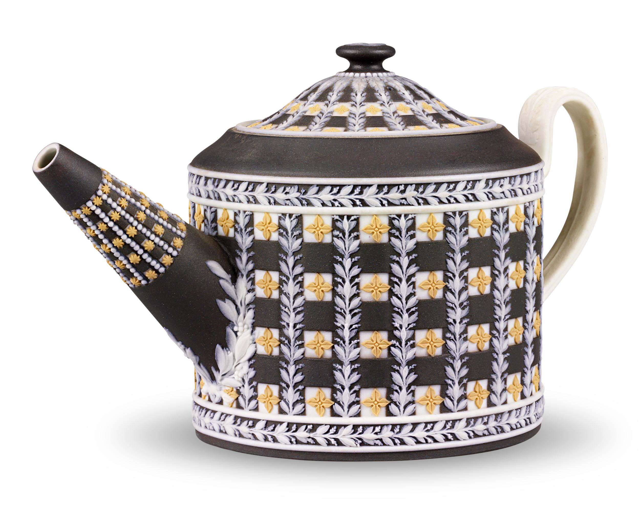 Crafted by Wedgwood, this exceptional three-piece tea set includes a teapot, creamer and lidded sugar bowl. The set features the famed English porcelain firm’s highly desirable and rare diceware motif. Golden yellow quatrefoil stars against white