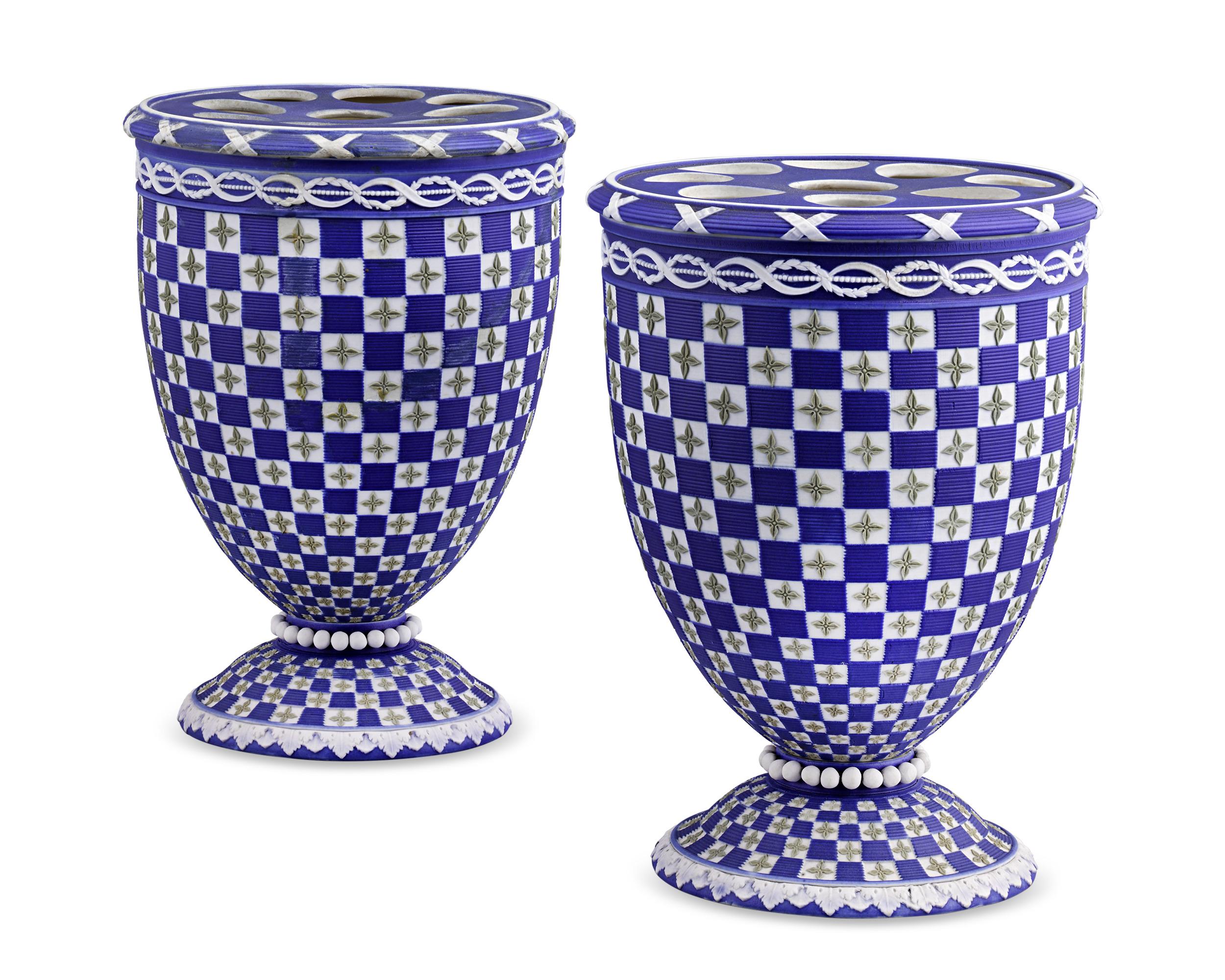 Crafted by Wedgwood, this pair of tricolor bough pots features a graphic design in the famed English porcelain firm’s highly desirable and rare diceware motif. Sage green quatrefoil stars against white porcelain squares alternate with brilliant blue