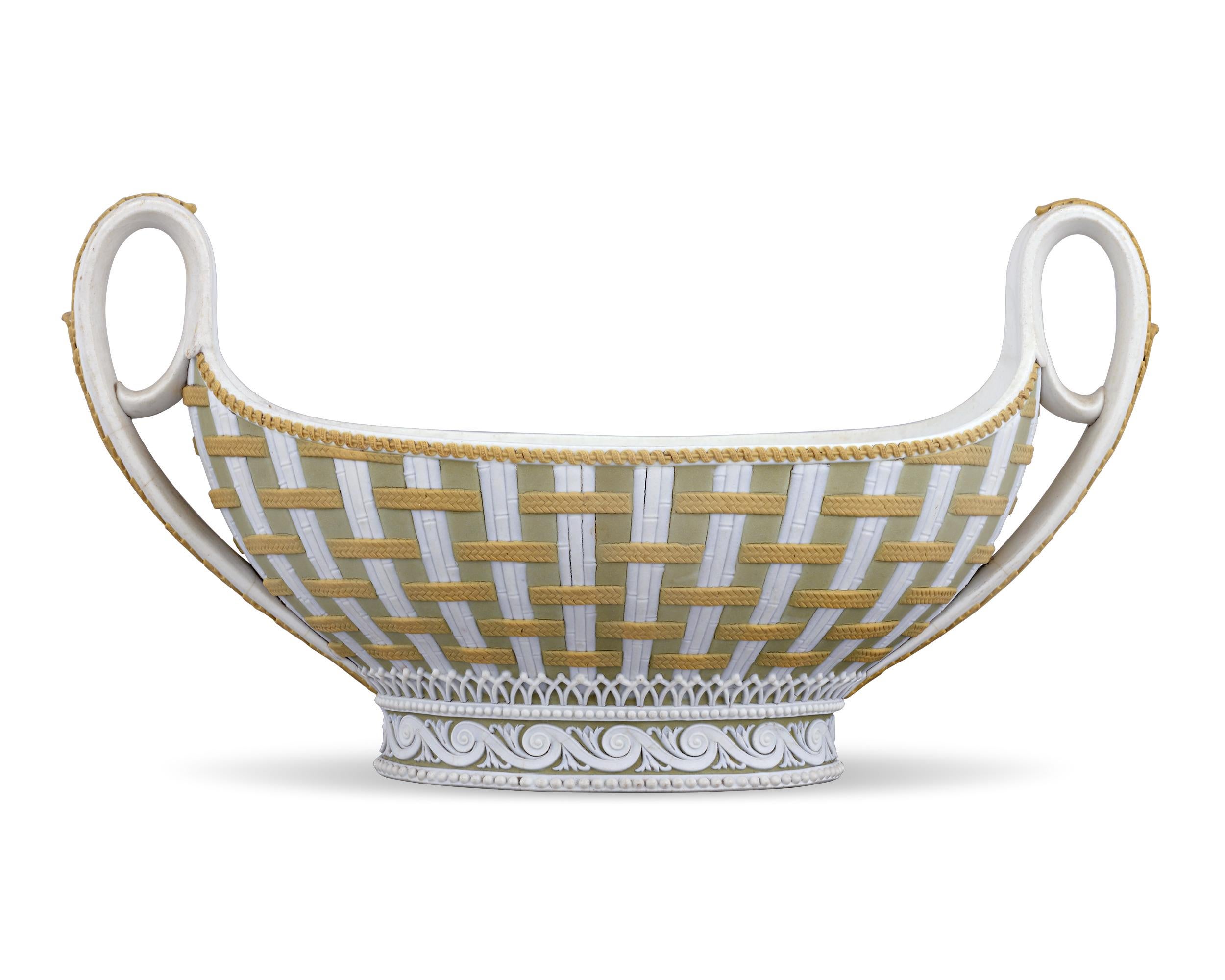 This exquisite Wedgwood sauceboat is crafted of tricolor jasperware, one of the firm's rarest creations. The sauceboat's classic form displays a beautifully woven pattern of white bamboo interlaced with cane-yellow strapwork reserved on sage green.