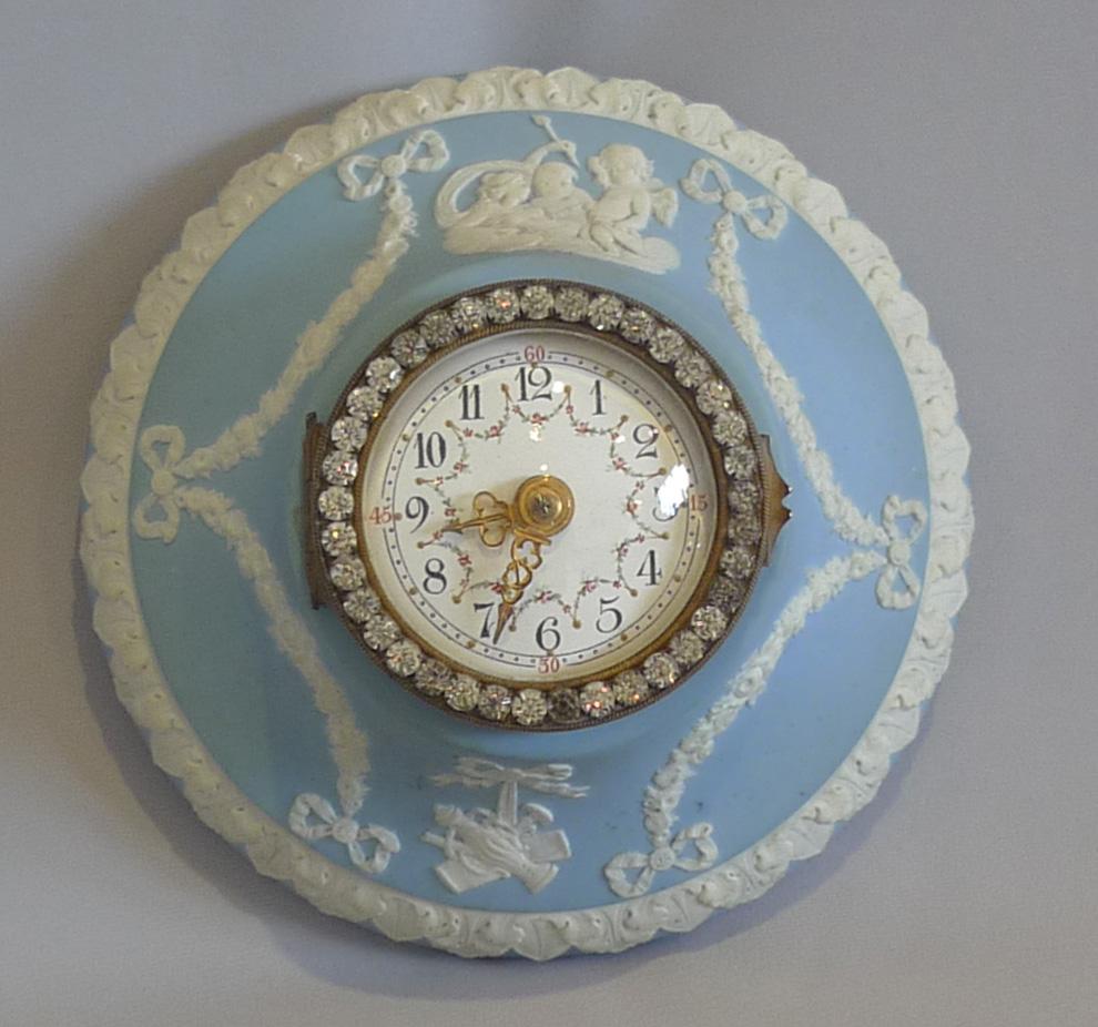 Wedgwood Jasperware wall clock. Of delicate size and extremely pretty this non striking timepiece clock would be perfect for a bedroom or other quiet area but would work well in an ordinary setting. The condition is mint with no chips or repairs.