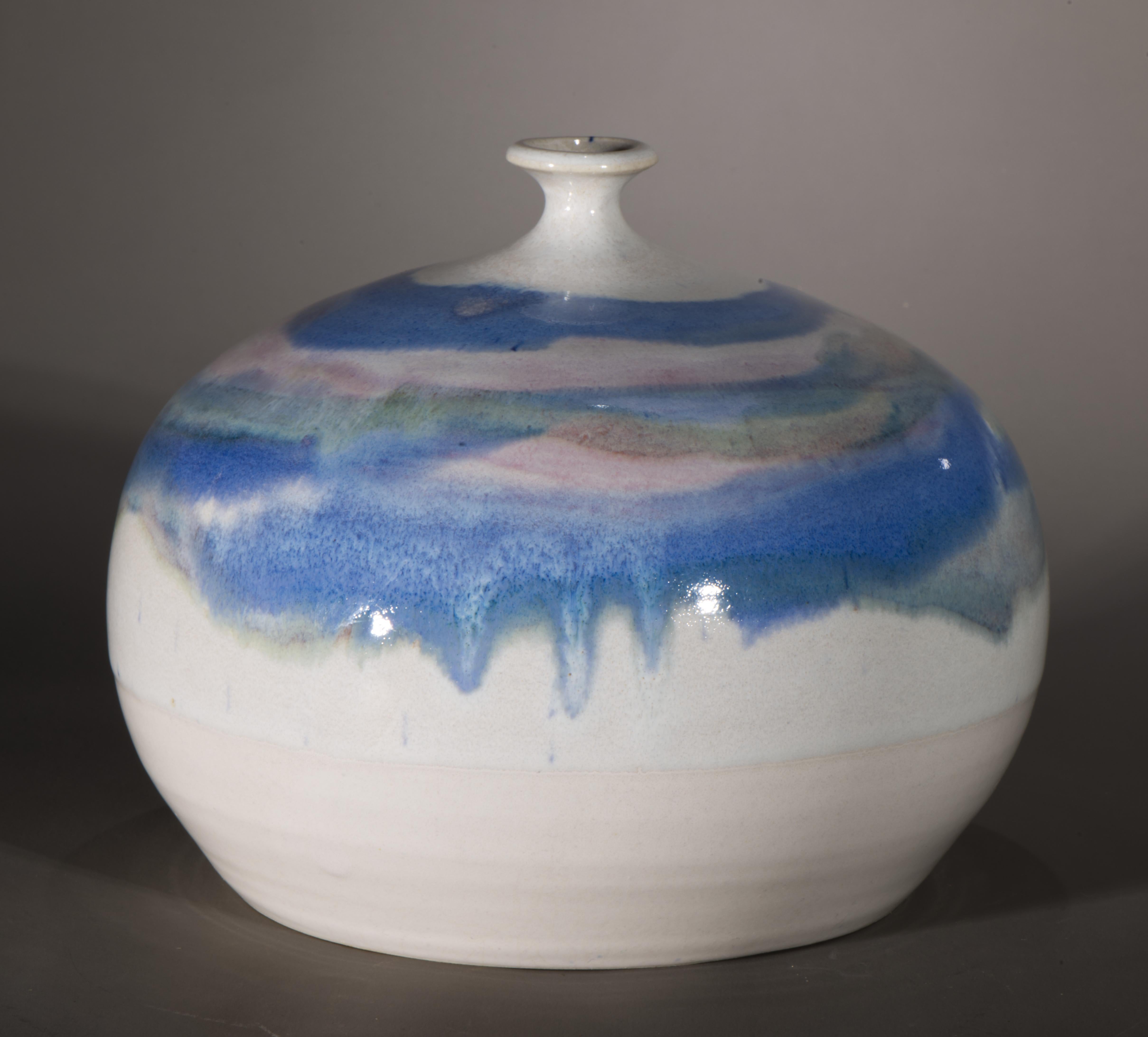 The striking vintage studio pottery ceramic vase is decorated with free-flowing drip glaze, hand-placed in circular pattern, accentuating the oversized shoulder and small opening, characteristic of the weed vase form. The Modernist shape of the