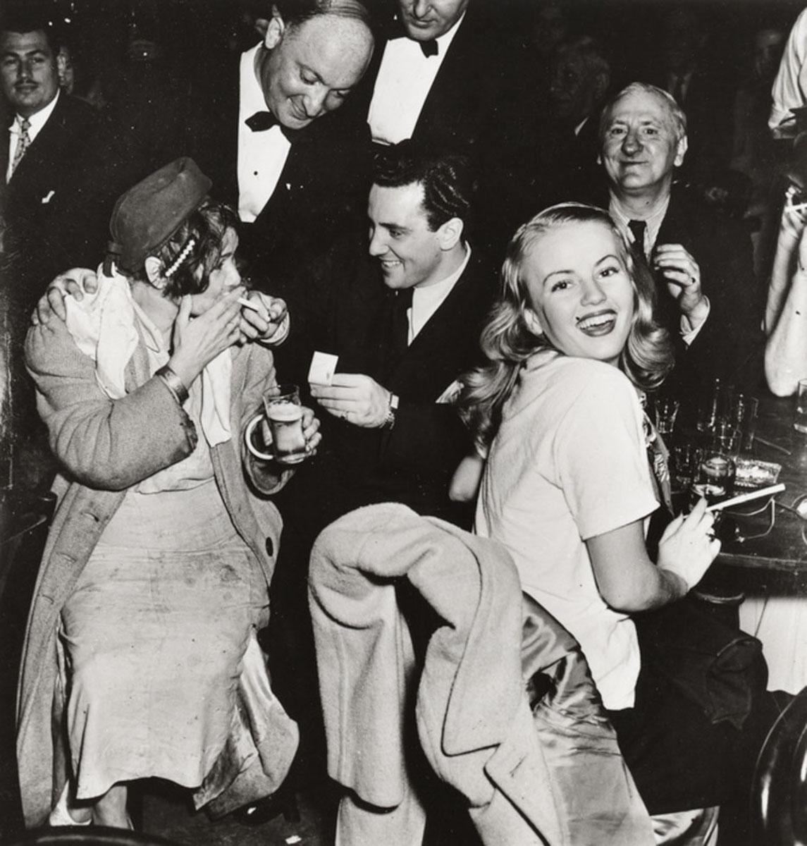 [Sammy Fuchs and Ethel, queen of the Bowery, Sammy’s on the Bowery, New York] - Photograph by Weegee