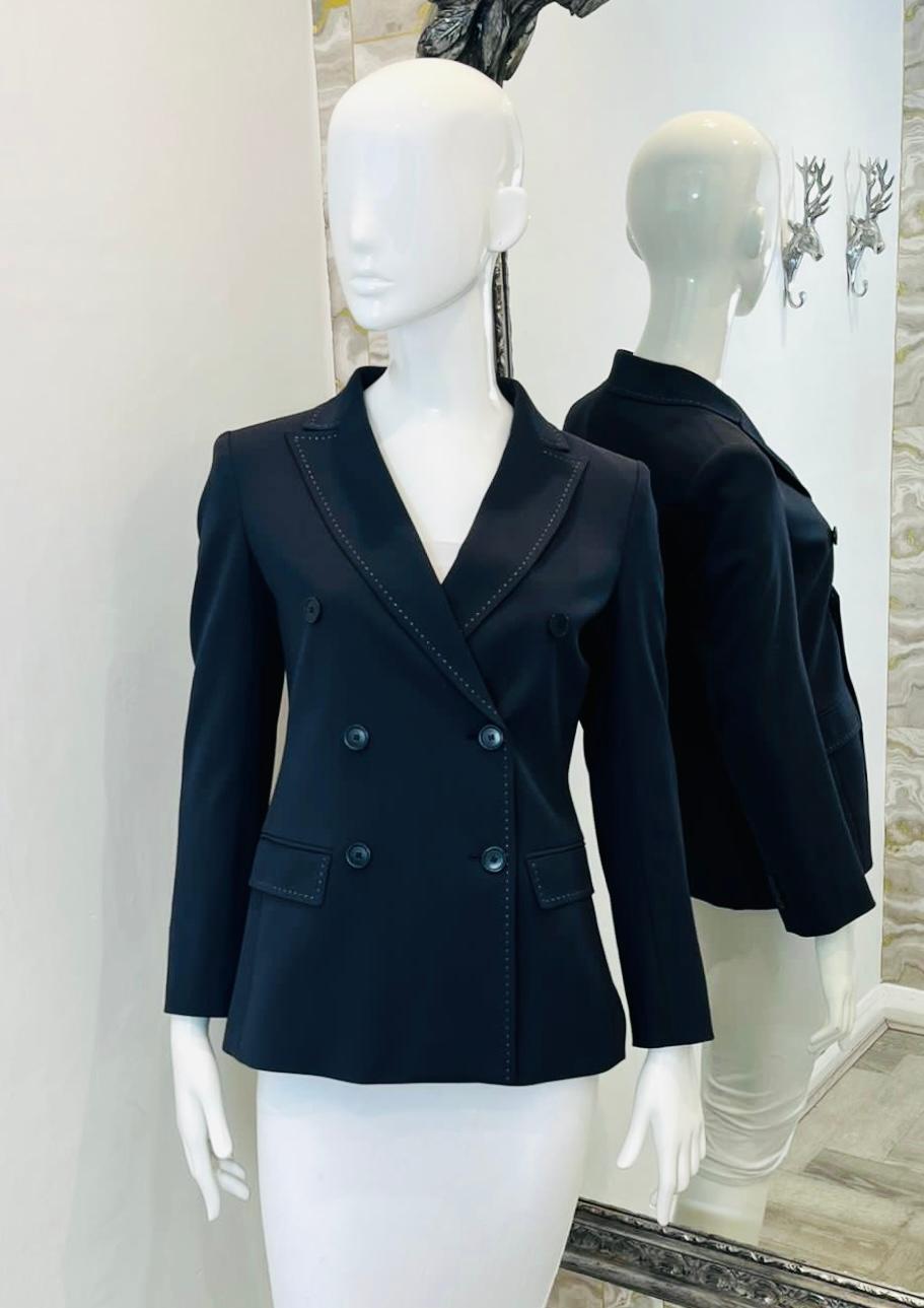 Weekend Max Mara Virgin Wool Blend Jacket

Navy double-breasted blazer designed with white contrast stitching details.

Featuring slim-fit silhouette, flap pockets to the sides and buttoned cuffs.

Size – 36FR

Condition – Very Good

Composition –
