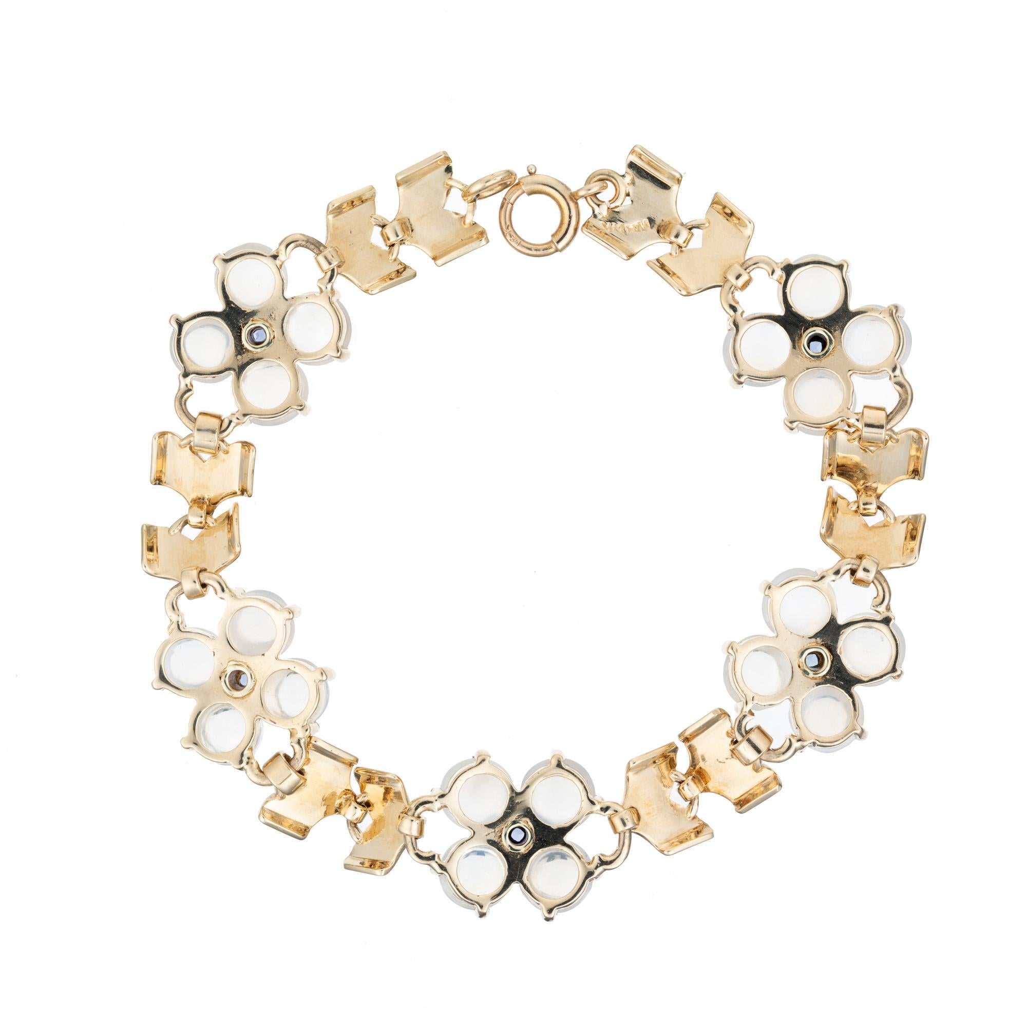 This 1940's Wefferling Berry designer bracelet features 20 stunning clear blue cabochon moonstones in five clusters of four with one square cut sapphire in the center of each cluster, with the sapphires totaling 1.11 carats. GIA certified the