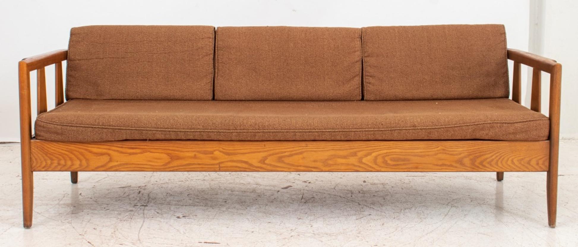 Danish Modern oak sofa in the manner of Hans Wegner (Danish, 1914-2007) of rectangular form, roll arms, and drop in cushions covered in brown boucle. Measures: 28
