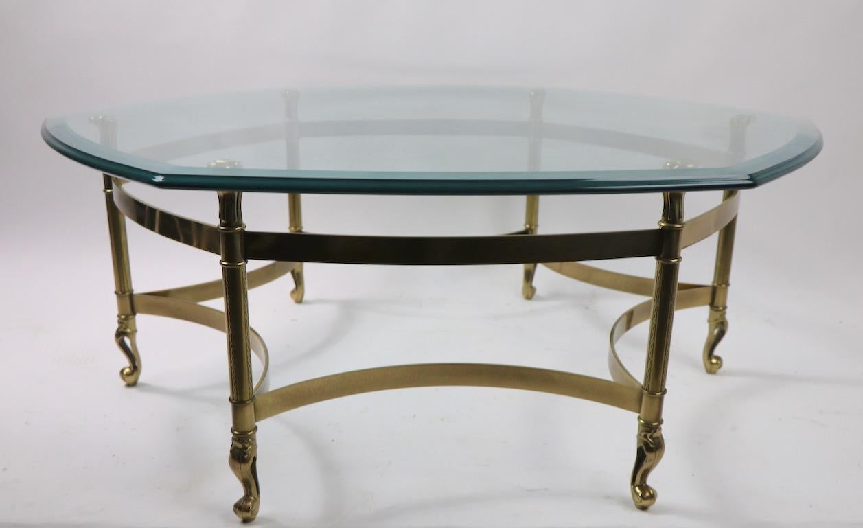 Classic form from highly regarded furniture maker Weiman. This elegant table has a hexagonal plate glass top with complex beveled edge, which rests on a stylized brass base. The table is in very Fine original condition, clean and ready to