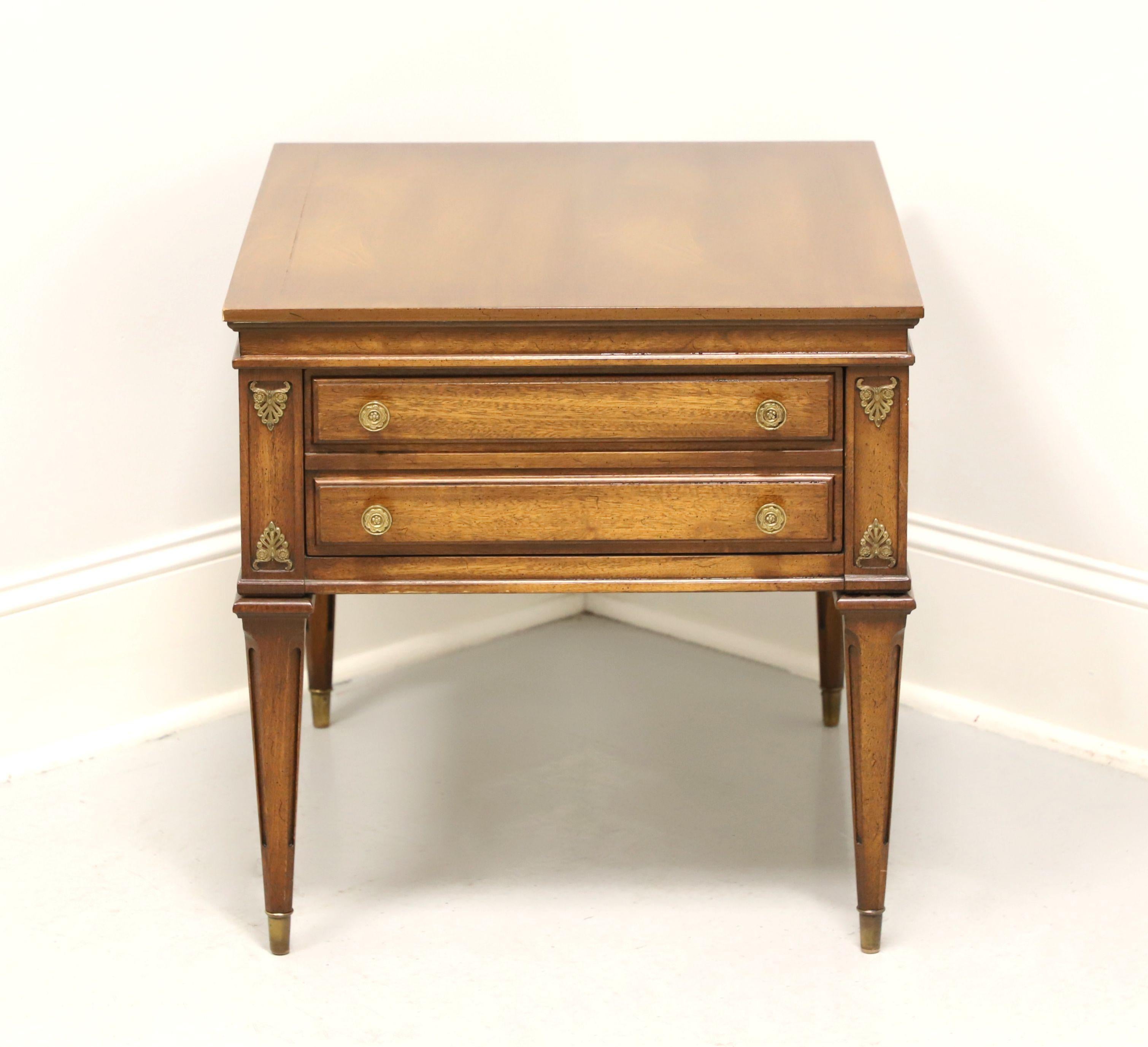 A mid 20th century side table by Weiman, from their Rockwood Collection. Mahogany with a lighter color finish, classic mid 20th Century styling, banded top, brass hardware & ornamentation, and straight tapered legs with brass caps. Features one