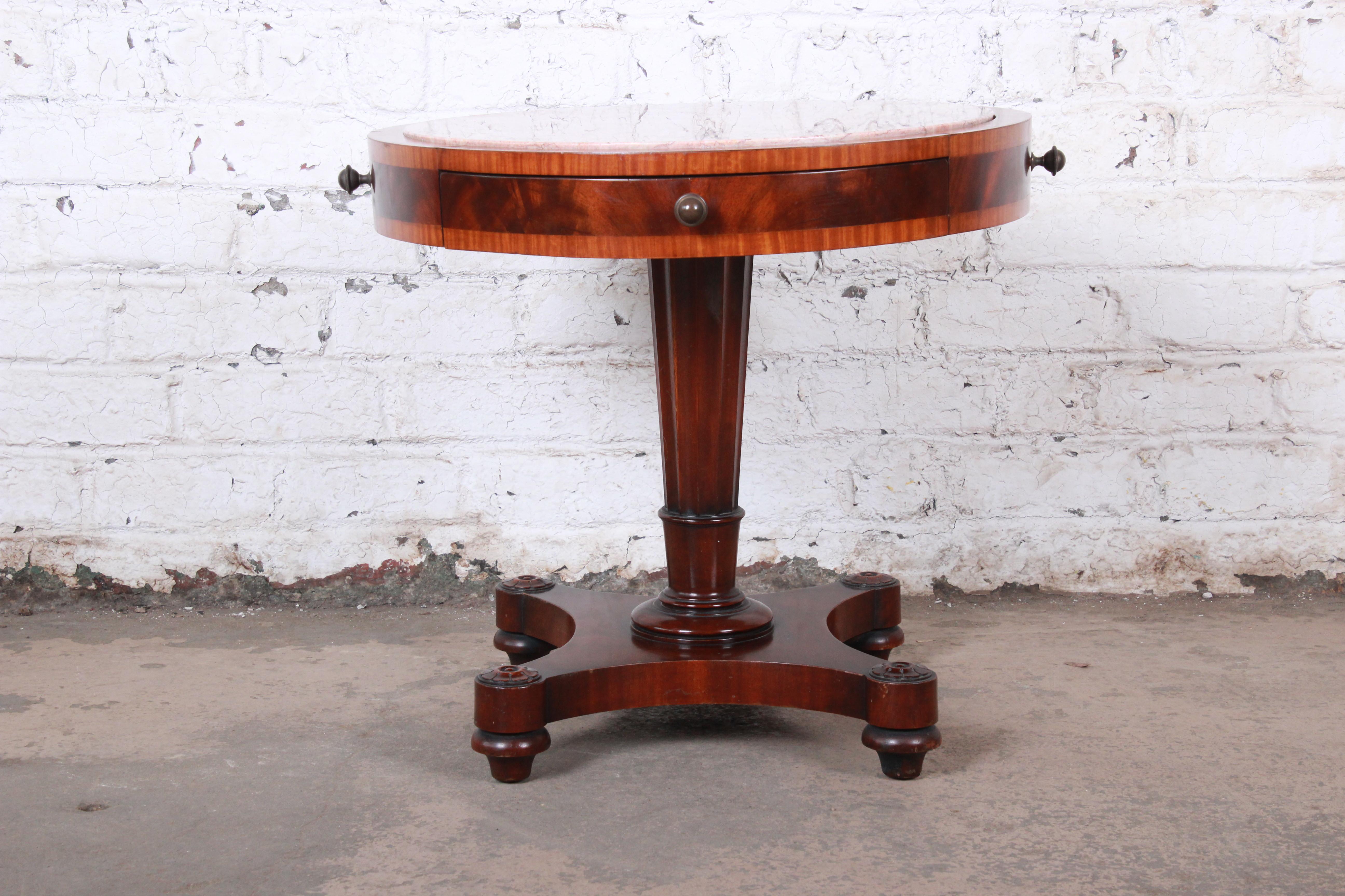 A gorgeous Regency style mahogany pedestal drum side table

By Weiman Furniture

USA, circa 1950s

Mahogany, marble and brass

Measures: 24.75
