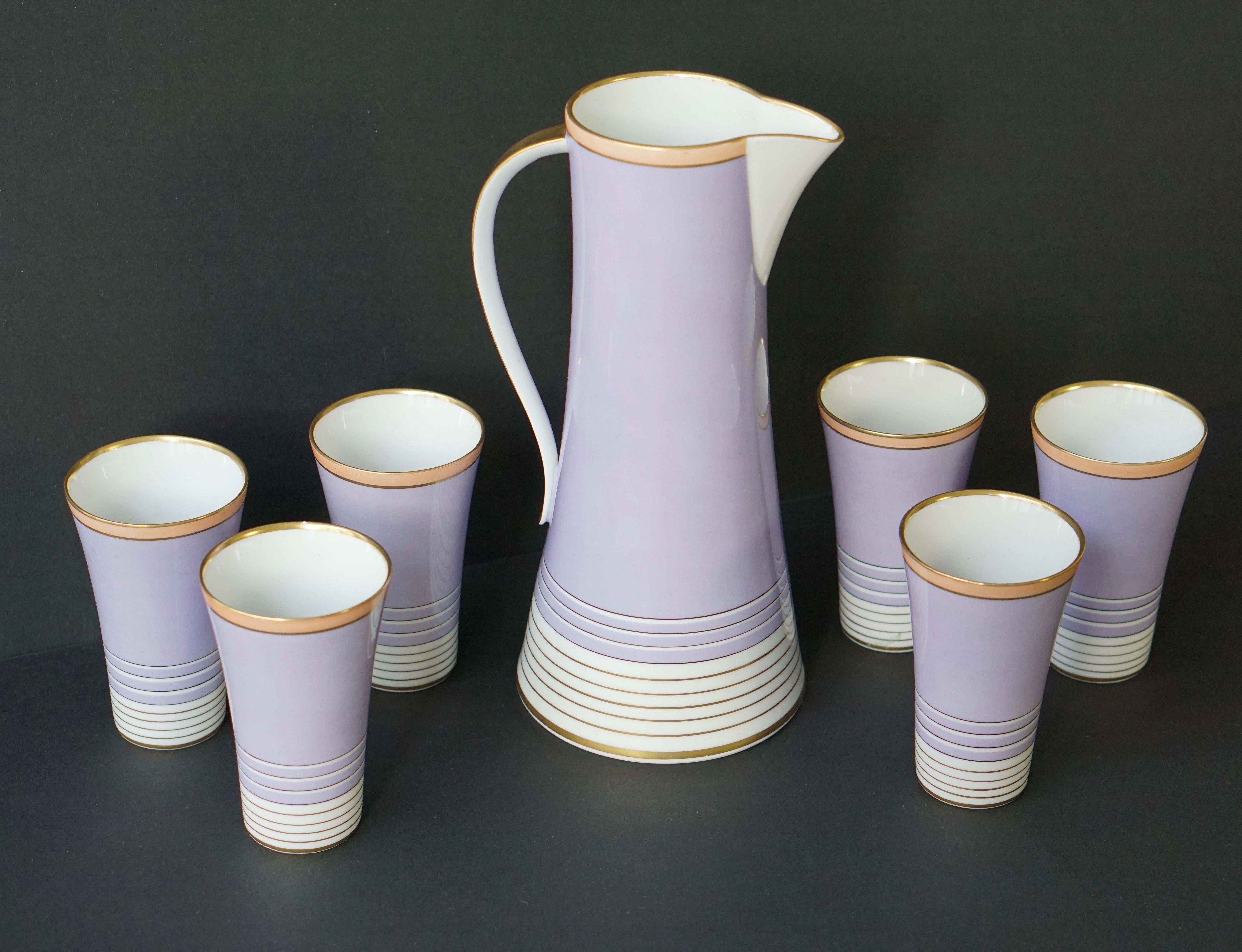 Drinking set composed of a jug and six glasses in violet, white and gilt. The jug and glasses are signed, Weimar porzellein, Germany, Romeo.
Jug dimension: Height 26 cm, depth 12cm, width 14 cm.
Glass dimension: Height 11cm, depth 7 cm.
    