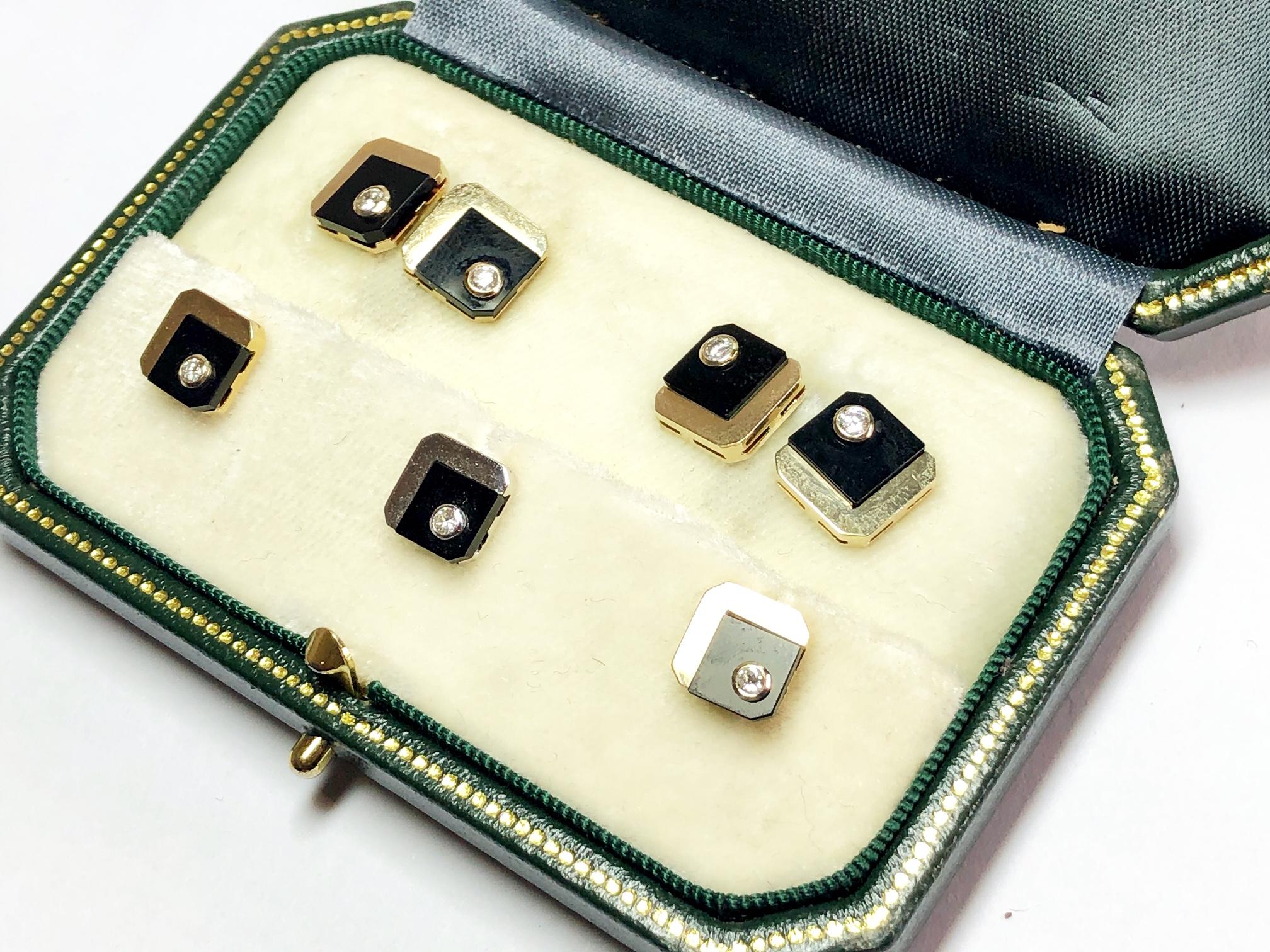 A black onyx and diamond dress set by Weingrill, mounted in 18ct yellow gold, set with black onyx and a diamond in each plate, in a square shape with cut corners. Signed Weingrill. Please note one stud has been plated white gold. Circa 1960.