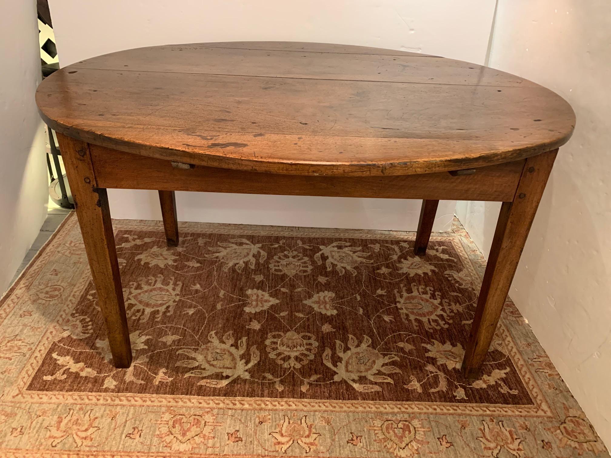 If tables could talk, this well loved gorgeous oval antique tavern table would have some great tales. The warm patina and obvious hand hewn craftsmanship with wooden pegs will give soul to any room. Perfect as a small dining table or breakfast