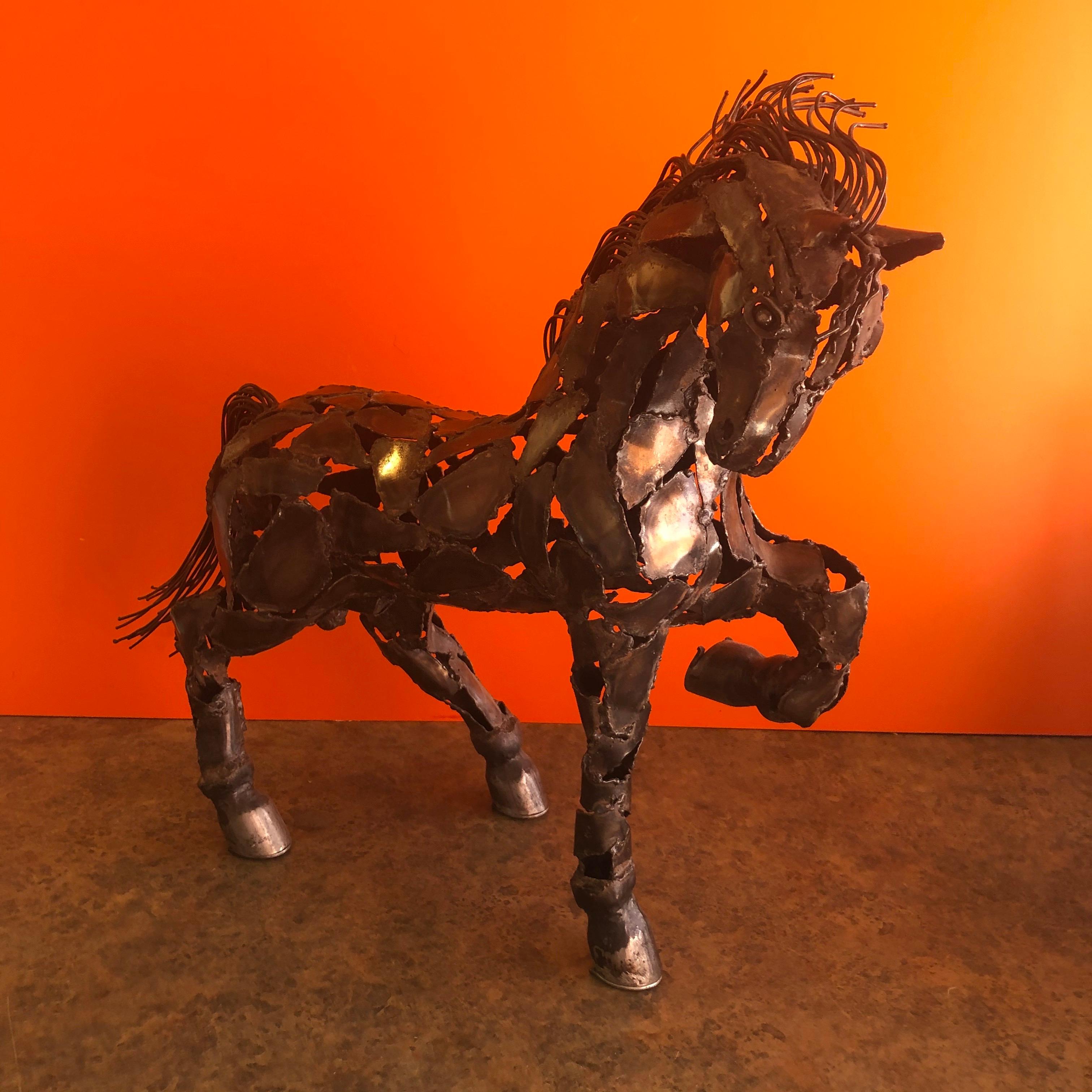 Wonderful welded metal horse sculpture in the style of Jiang Tie-Feng, circa 1980s. The piece is signed on the underside 