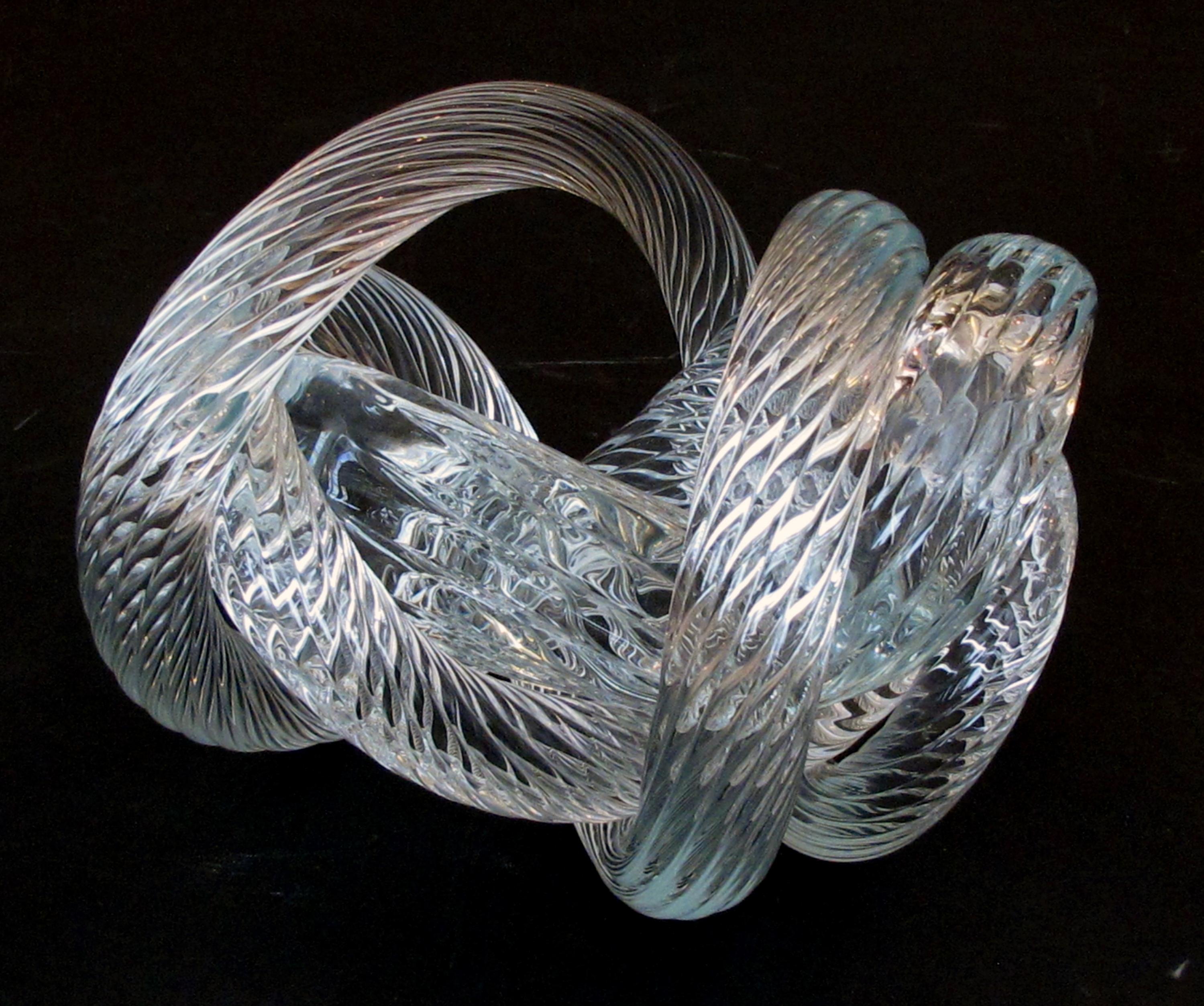 A well-crafted and heavy glass rope knot by Fusion Z Glassworks; with acid etched signature; the thickly-modeled sculpture depicting an intertwining rope in shimmering glass.