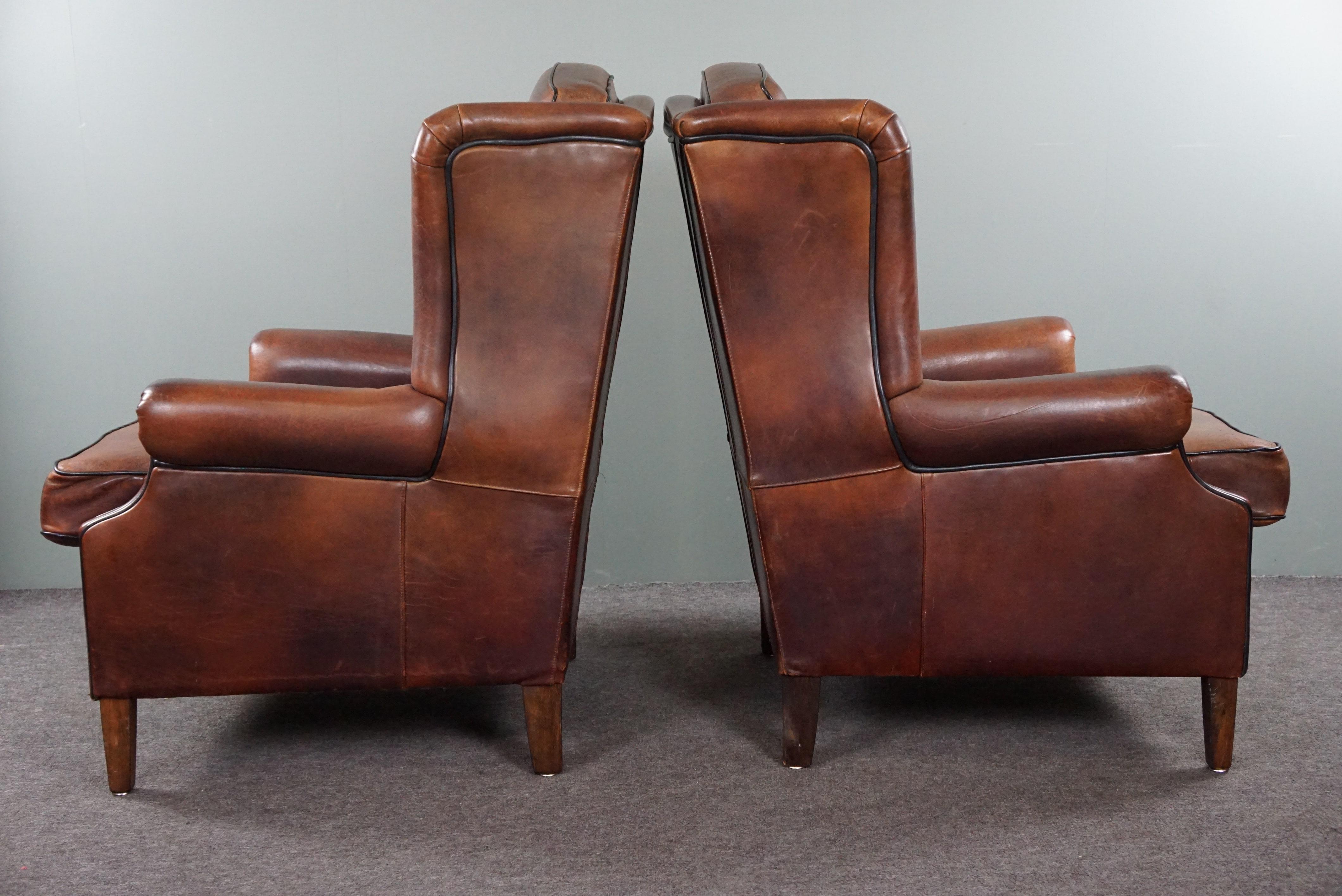 Hand-Crafted Well-fitting set of 2 sheep leather wing chairs For Sale