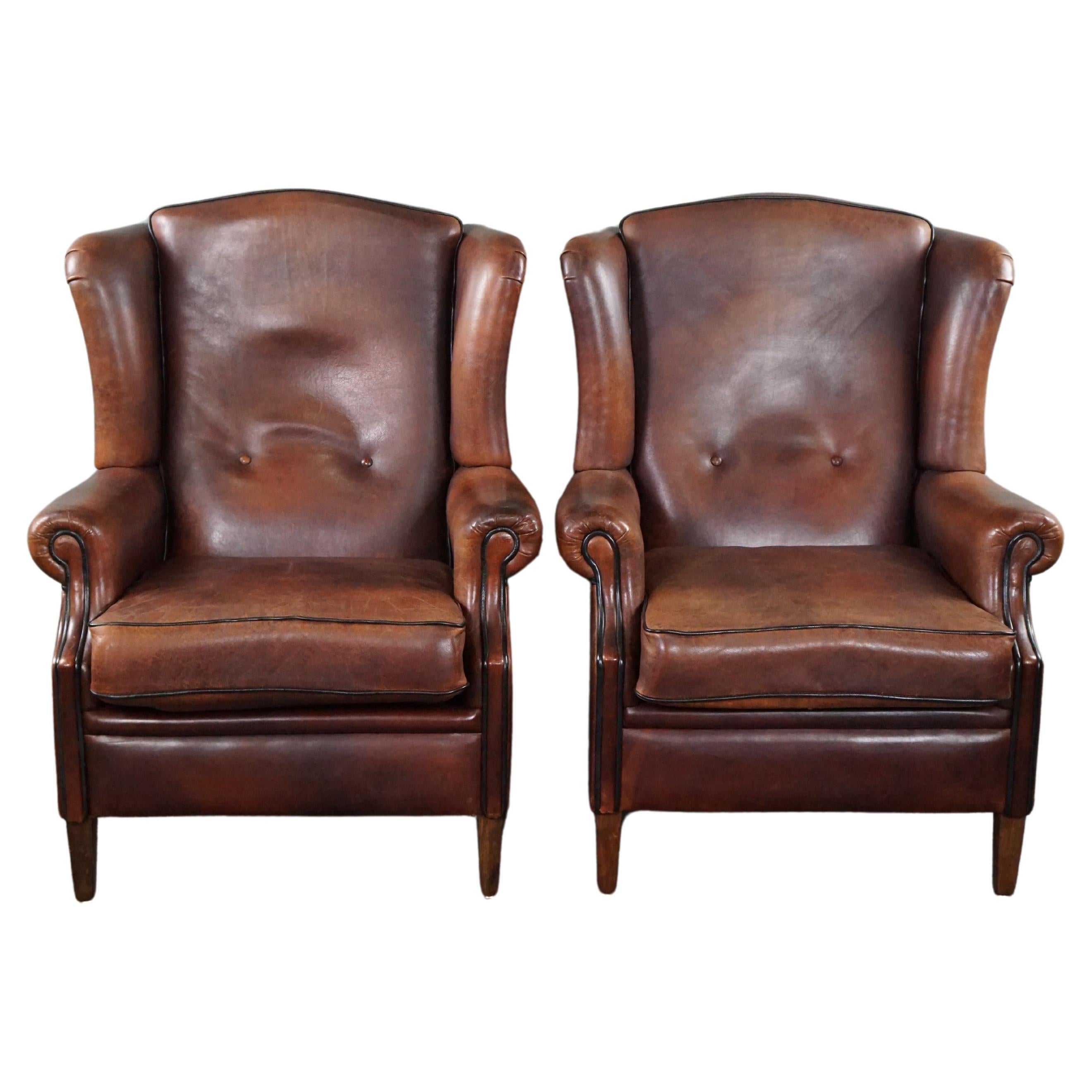 Well-fitting set of 2 sheep leather wing chairs For Sale