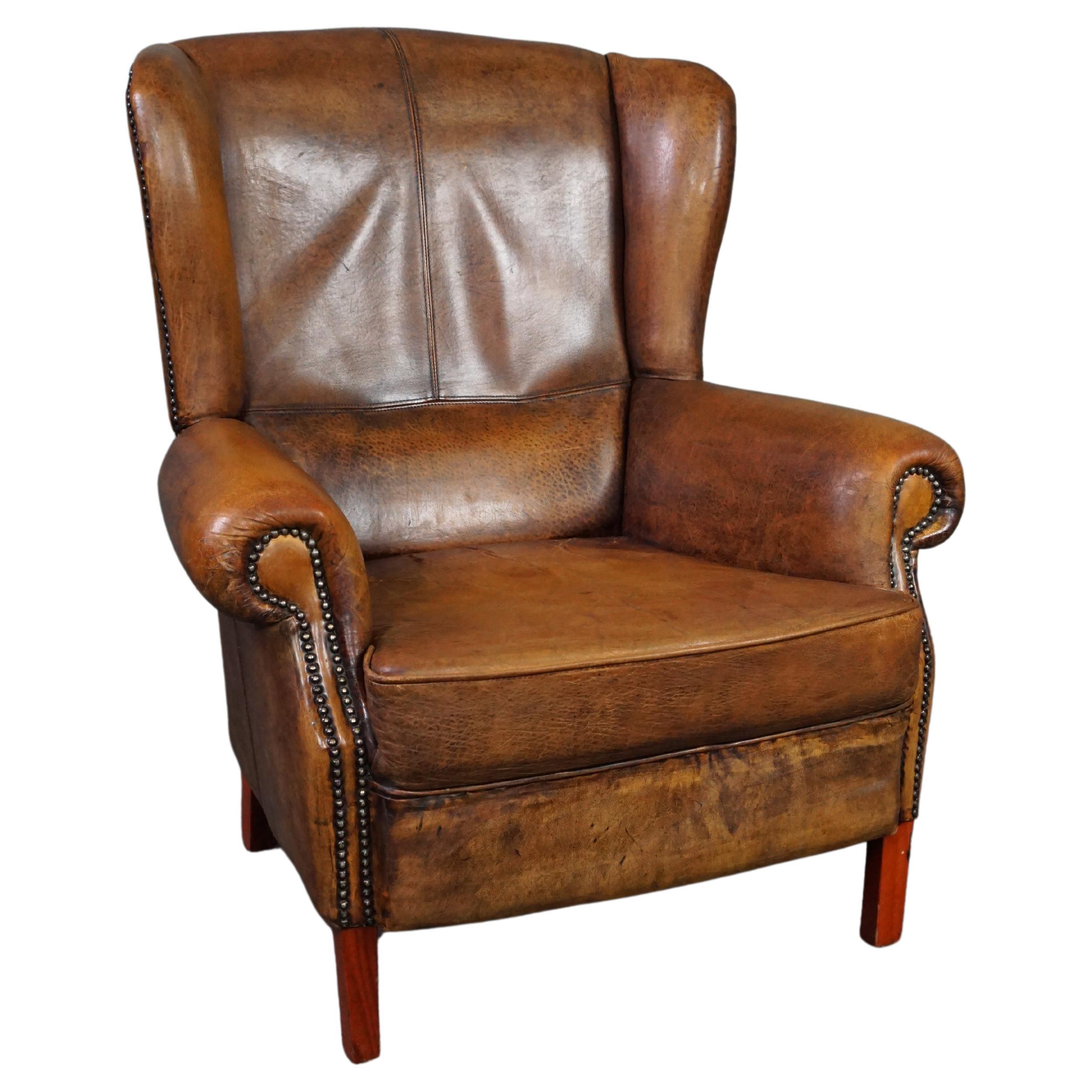 Well-fitting sheepskin leather wing chair