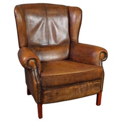 Well-fitting sheepskin leather wing chair