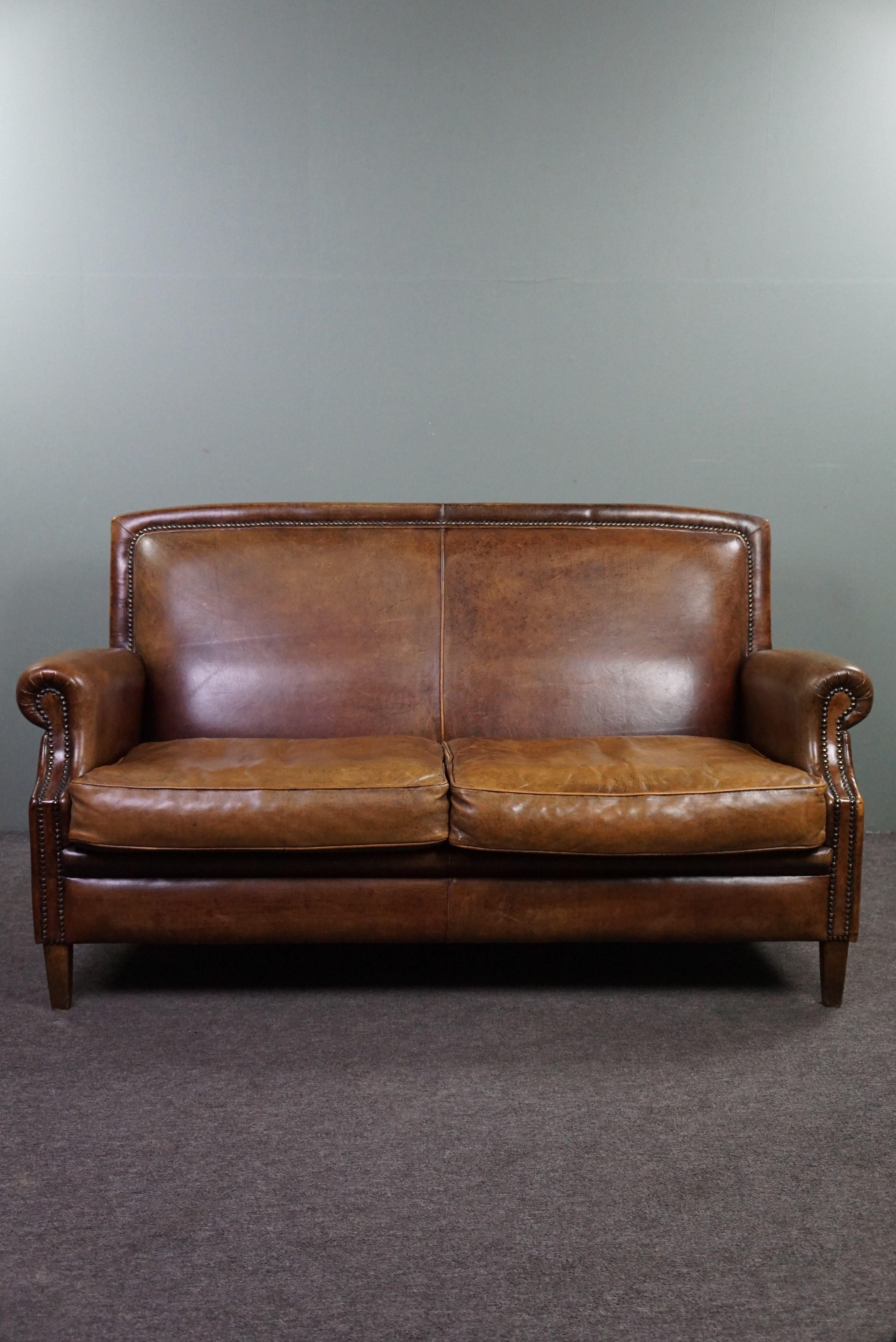 Offered is this well-fitting sheepskin leather 2-seater sofa. This beautiful sheepskin leather sofa is exquisite in color, form, and size, providing excellent comfort and a premium look and feel. With its rich and vibrant colors, lovely panel