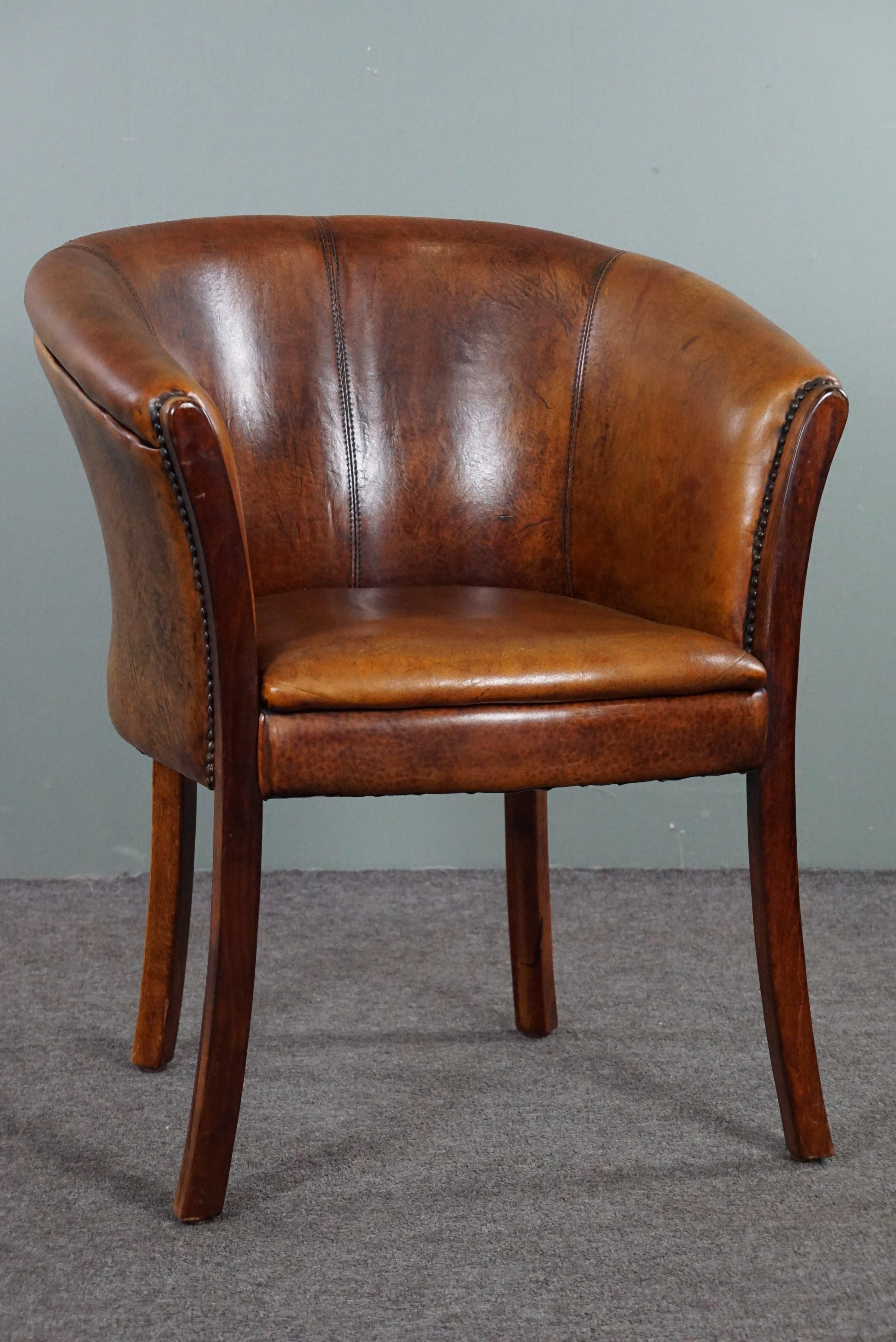 Offered is this beautiful subtle and slender sheepskin chair finished with decorative nails.

This sheep leather armchair or side chair is multifunctional due to its modest size and higher seat height. This makes this sheepskin tubchair suitable for