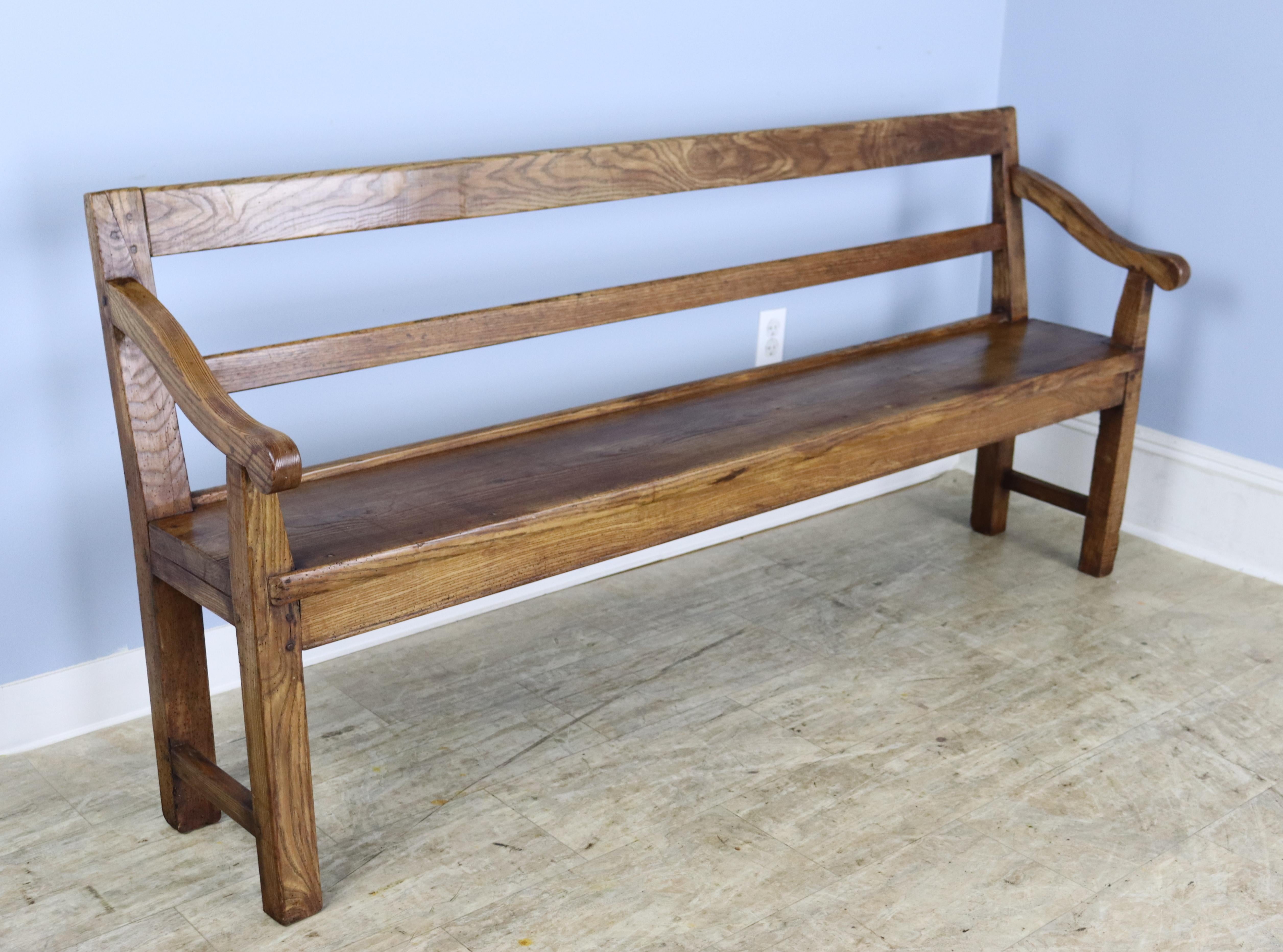 A classic sleight armed bench in dramtically grained and patinated ash.  Beautiful color and a nice size for the hallway, mudroom or at the end of a king sized bed.