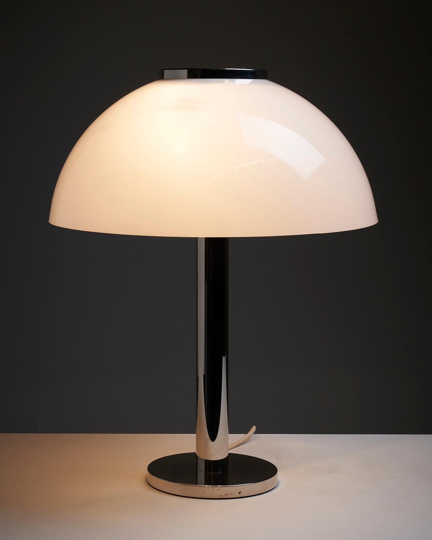 Illuminate your space with the sleek and stylish Dome table lamp by Beisl Leuchten. This German-designed lamp combines a glimmering chrome base and stem, exuding a touch of sophistication and modern elegance.

At the top of the stem, you'll find a
