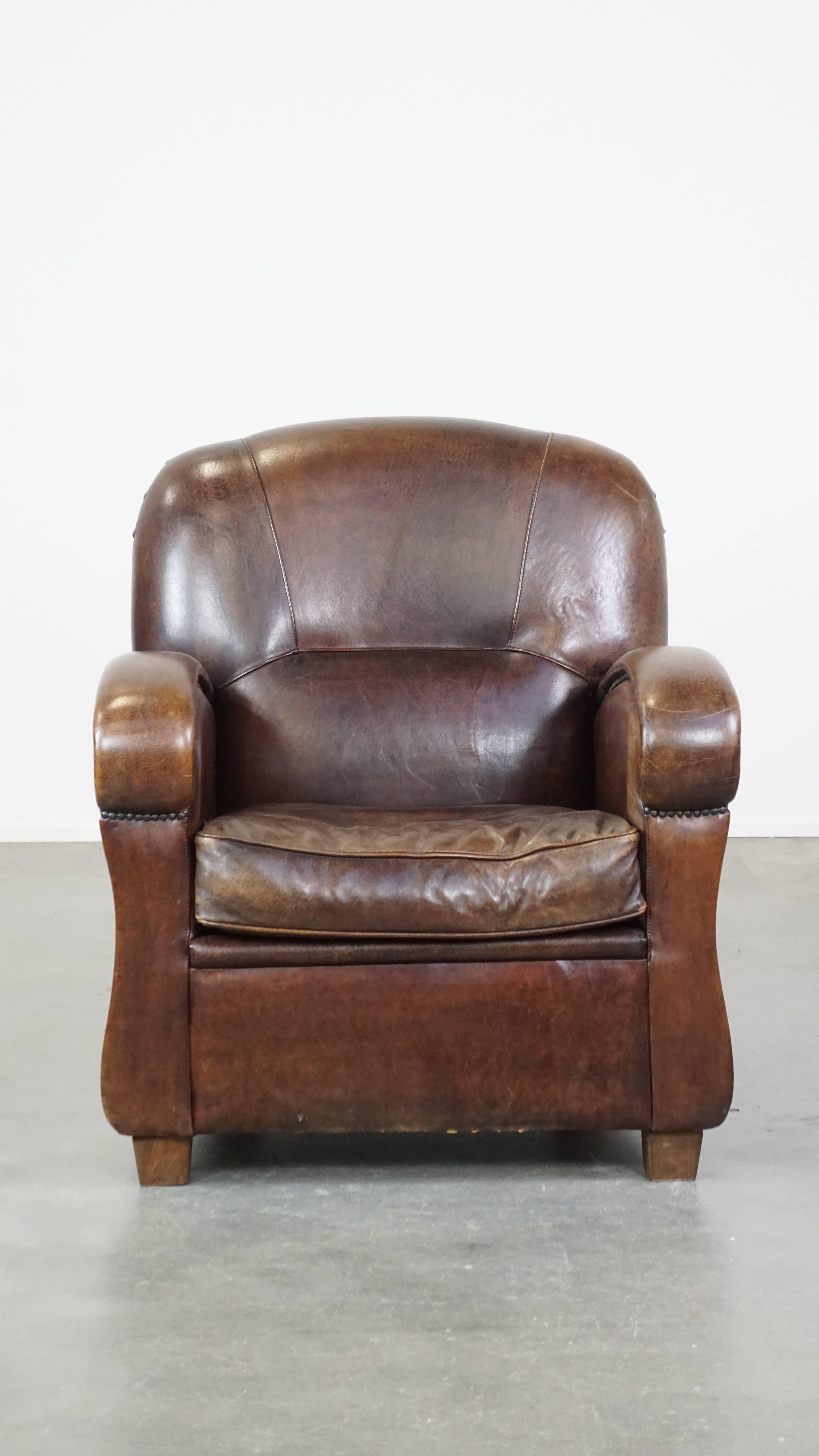Questa meravigliosa poltrona in pelle di pecora scura si adatta perfettamente a quasi tutti gli interni. Ha forme eleganti e arrotondate ed è rifinito con chiodi decorativi che gli conferiscono un aspetto raffinato e di classe. Questa poltrona è
