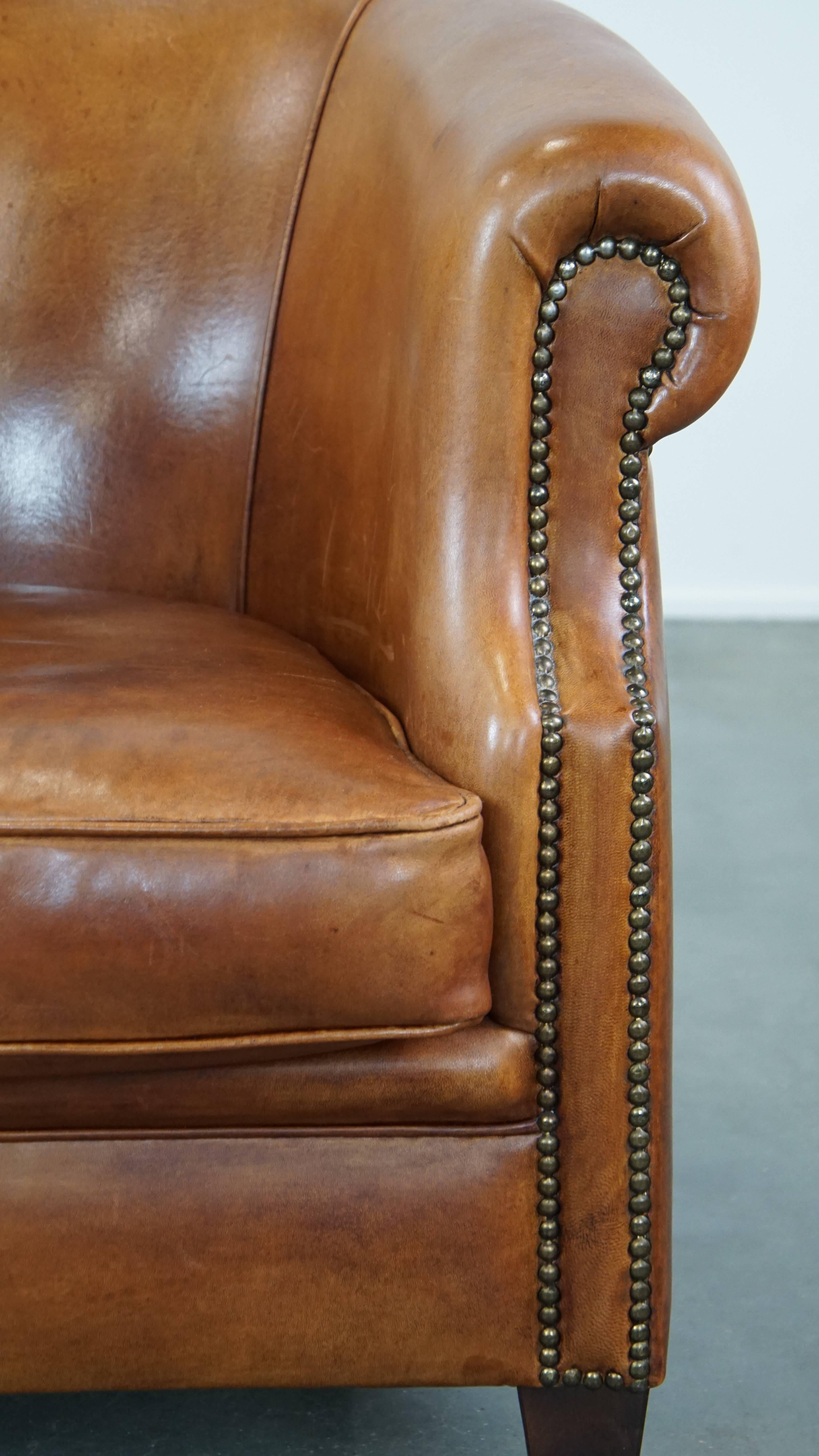 Well-maintained sheepskin club armchair with finished with decorative nails For Sale 4