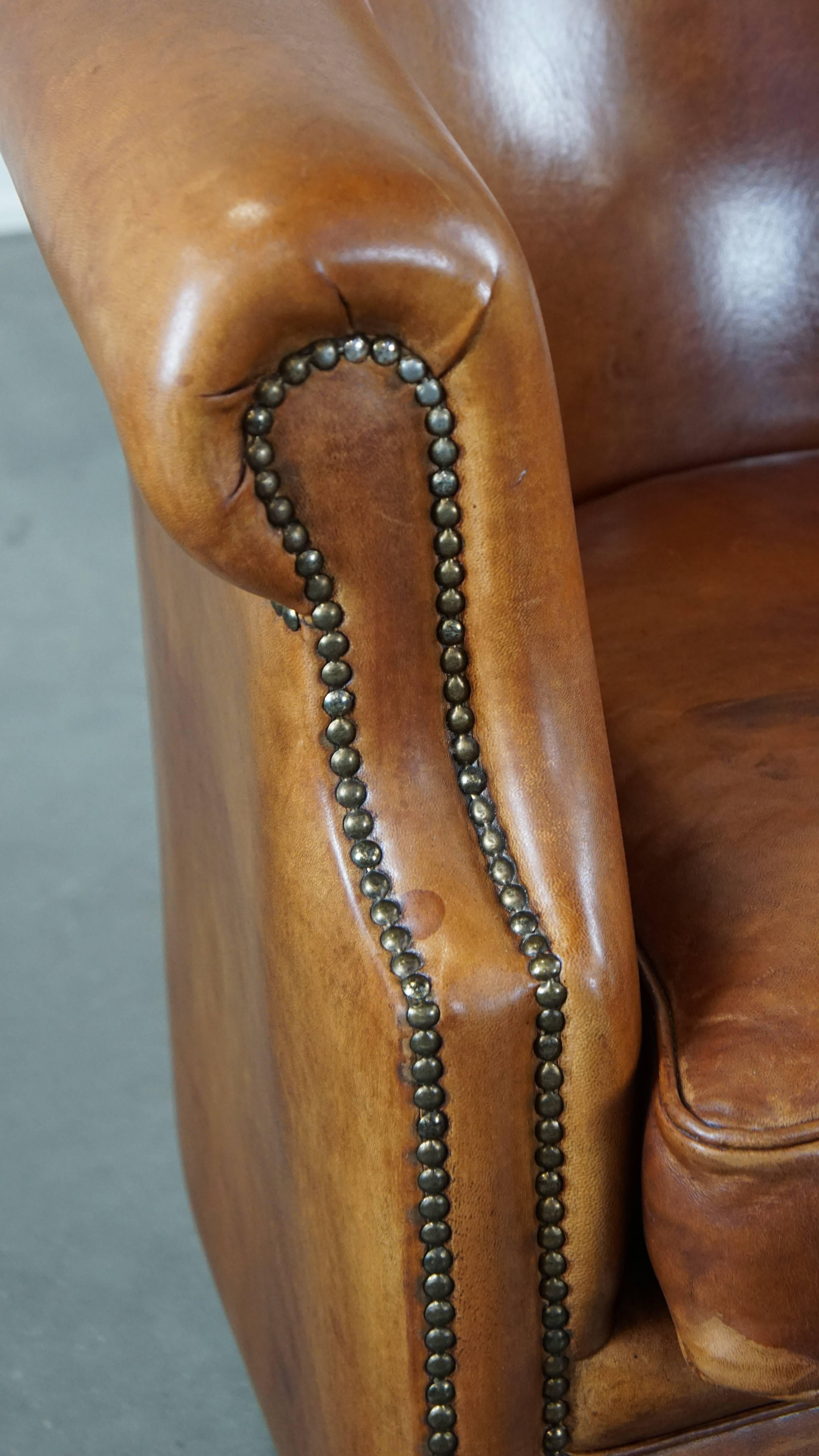 Well-maintained sheepskin club armchair with finished with decorative nails For Sale 5