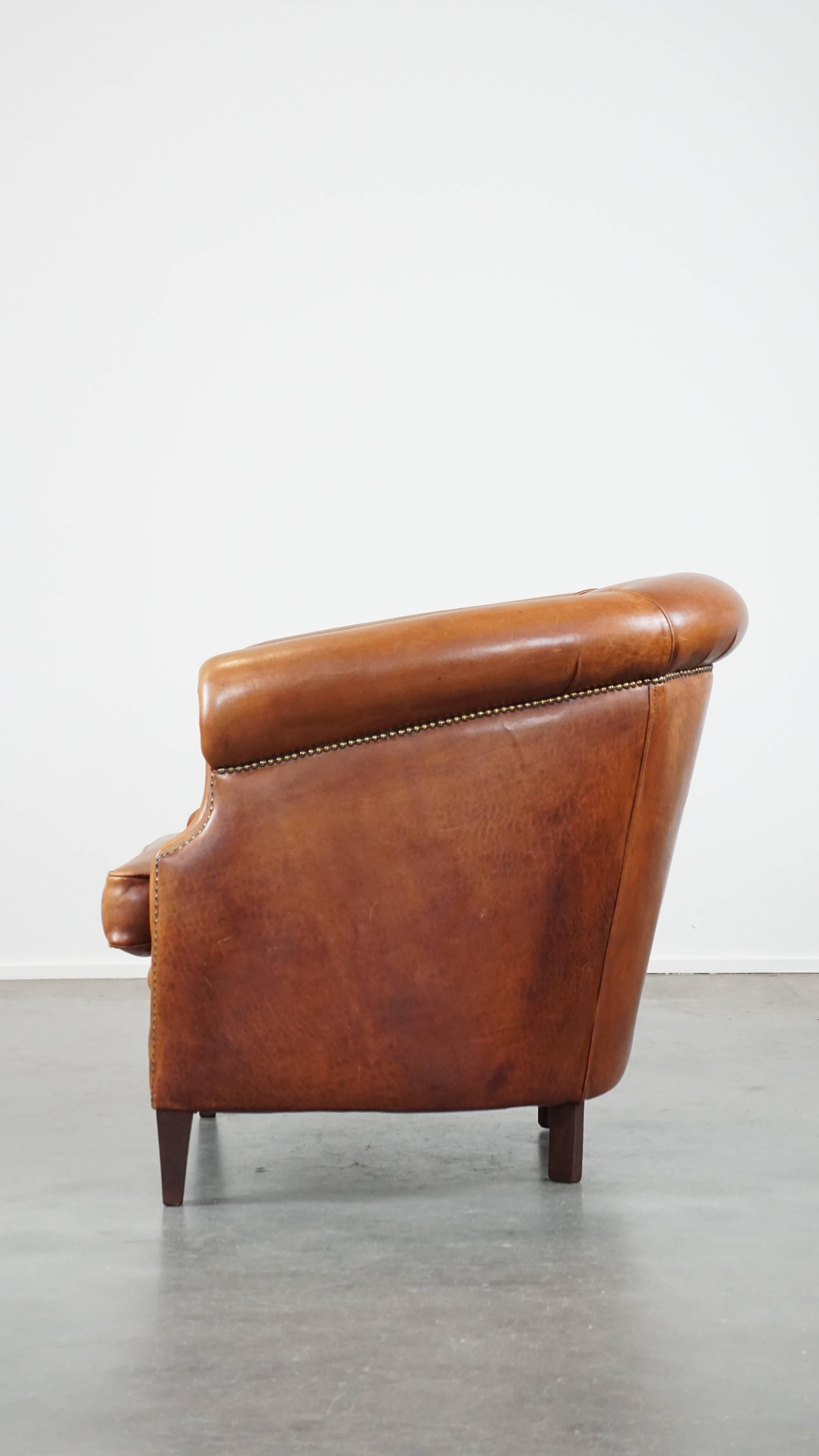 20th Century Well-maintained sheepskin club armchair with finished with decorative nails For Sale