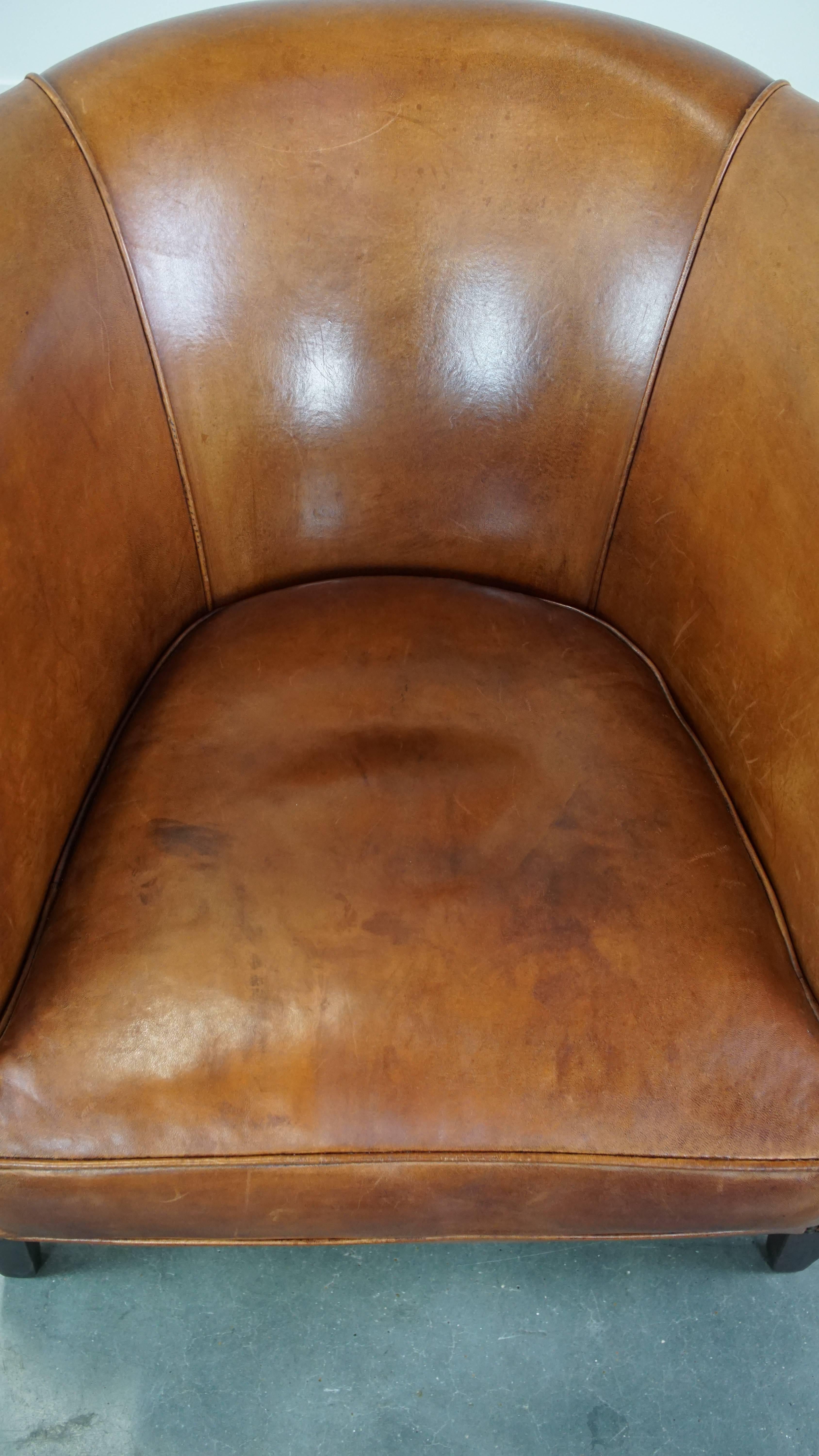 Leather Well-maintained sheepskin club armchair with finished with decorative nails For Sale