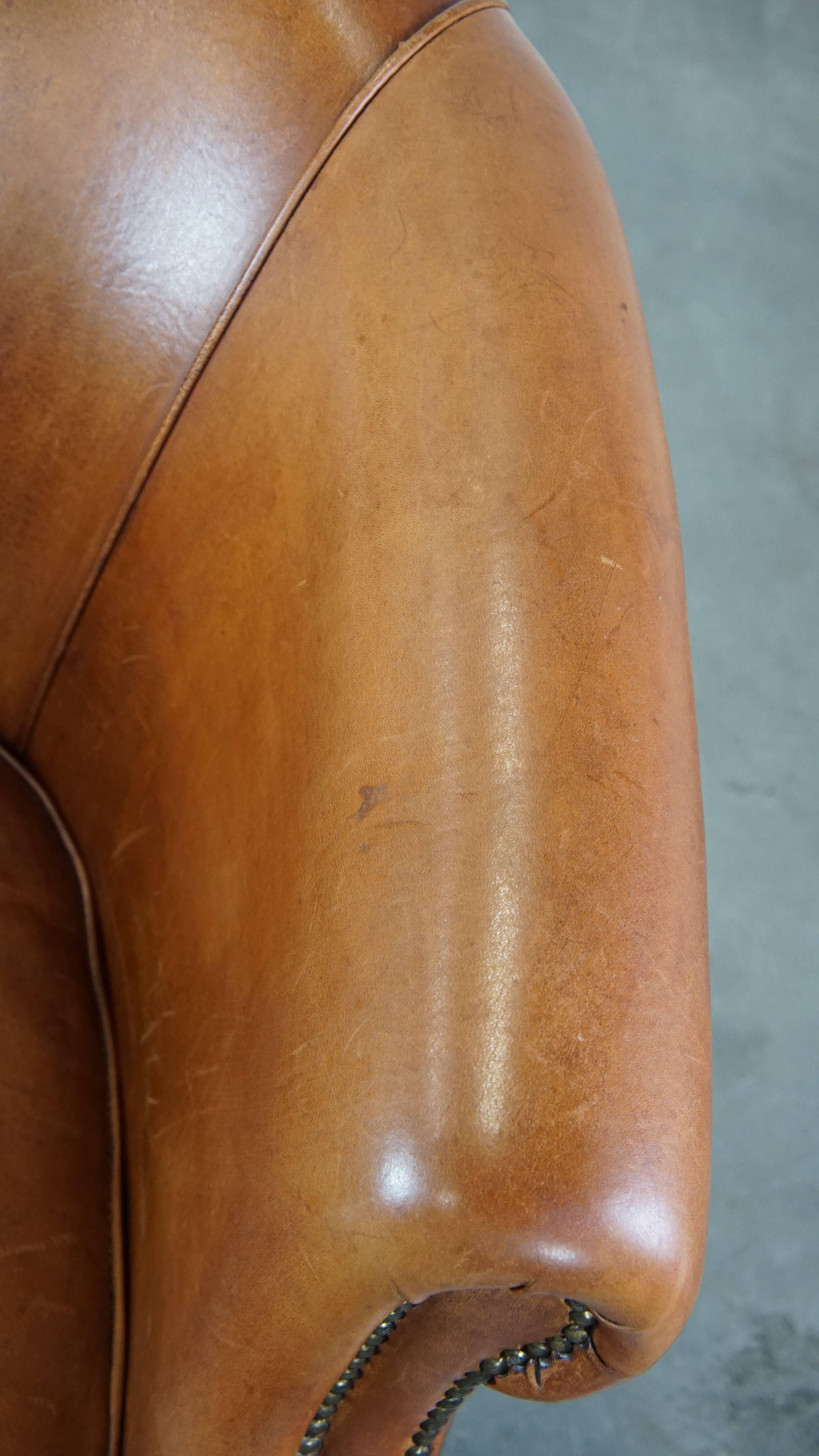 Well-maintained sheepskin club armchair with finished with decorative nails For Sale 2