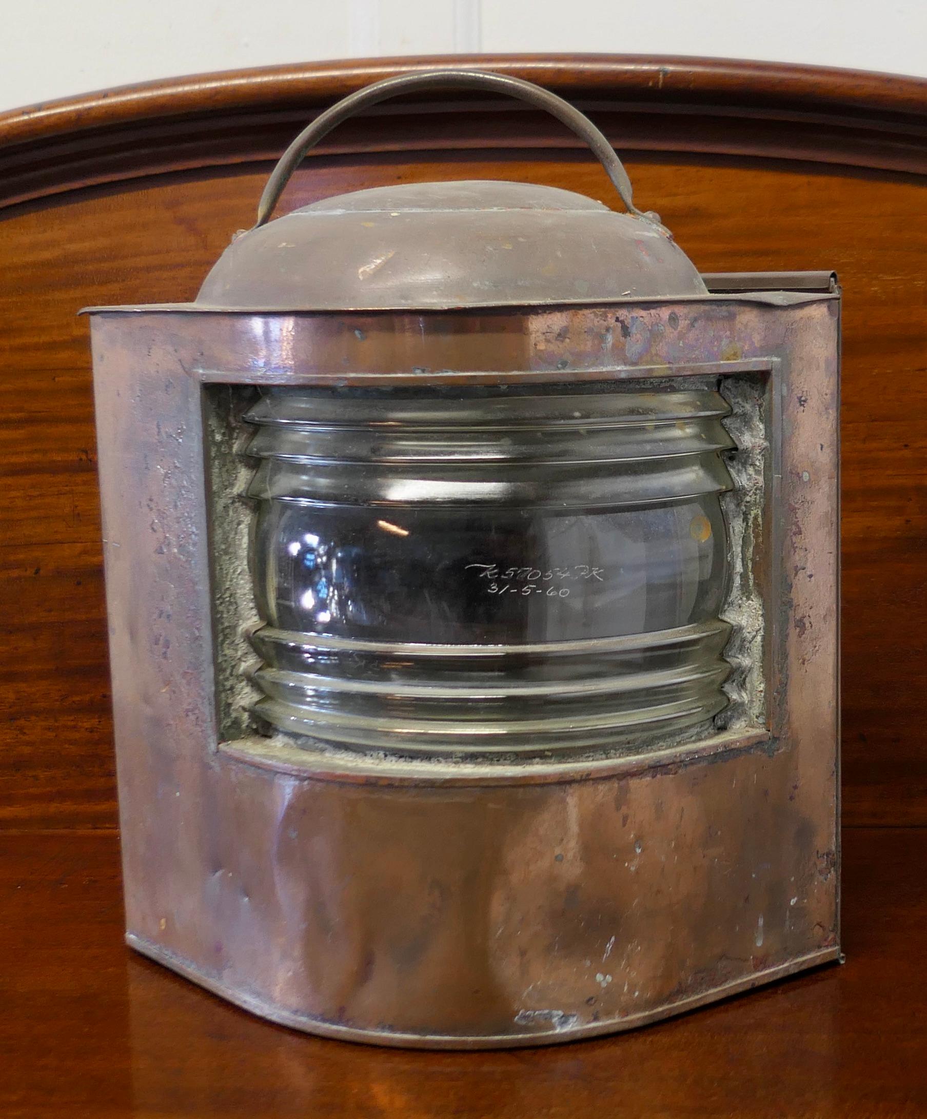 Well Weathered Ships Copper Navigation Light.

The lamp is flat sided with original bowed and ridged glass front, this has the date which it was last replaced etched on the front
A great decorators lamp, no spirit burner, a good marine piece which