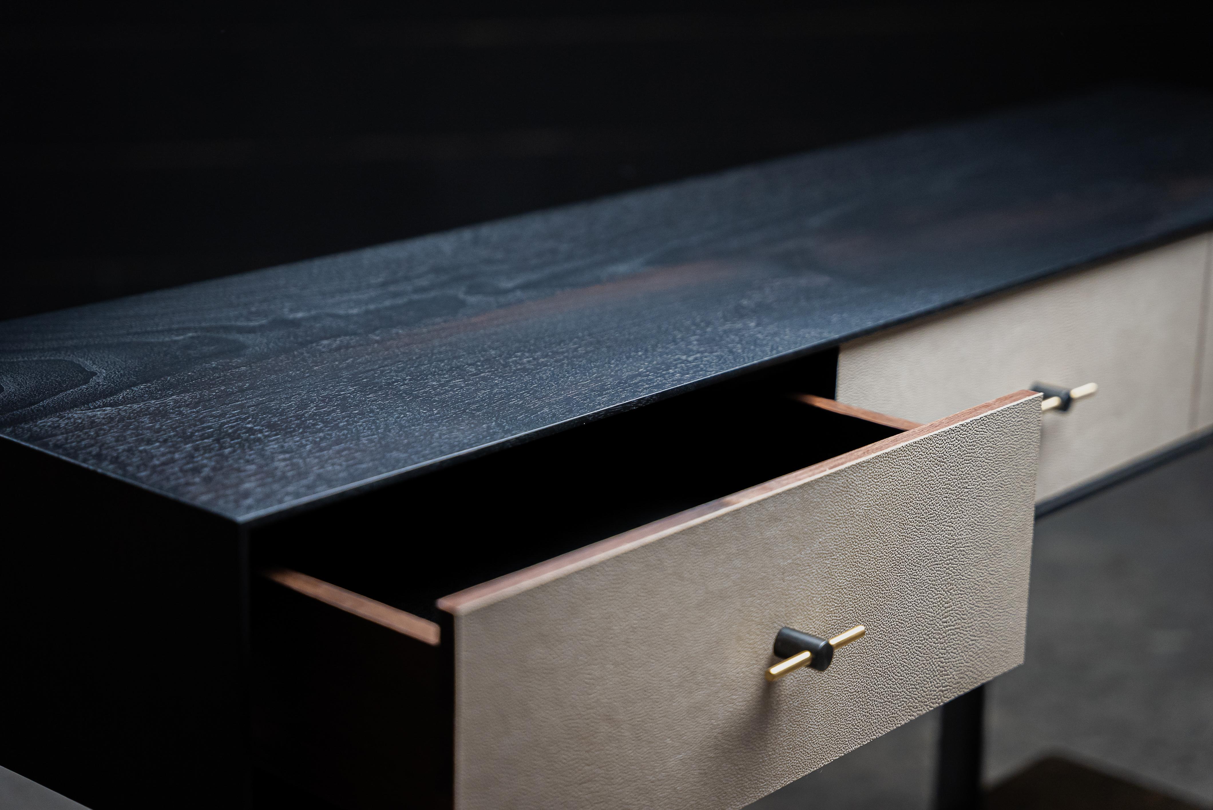 The Welland Console is made-to-order. Designed to store daily and occasional objects. The three solid wood drawers are featuring Shagreen veneer front and velvet bottom. The solid brass hardware are studio-machined with hand blackened finish. Wood