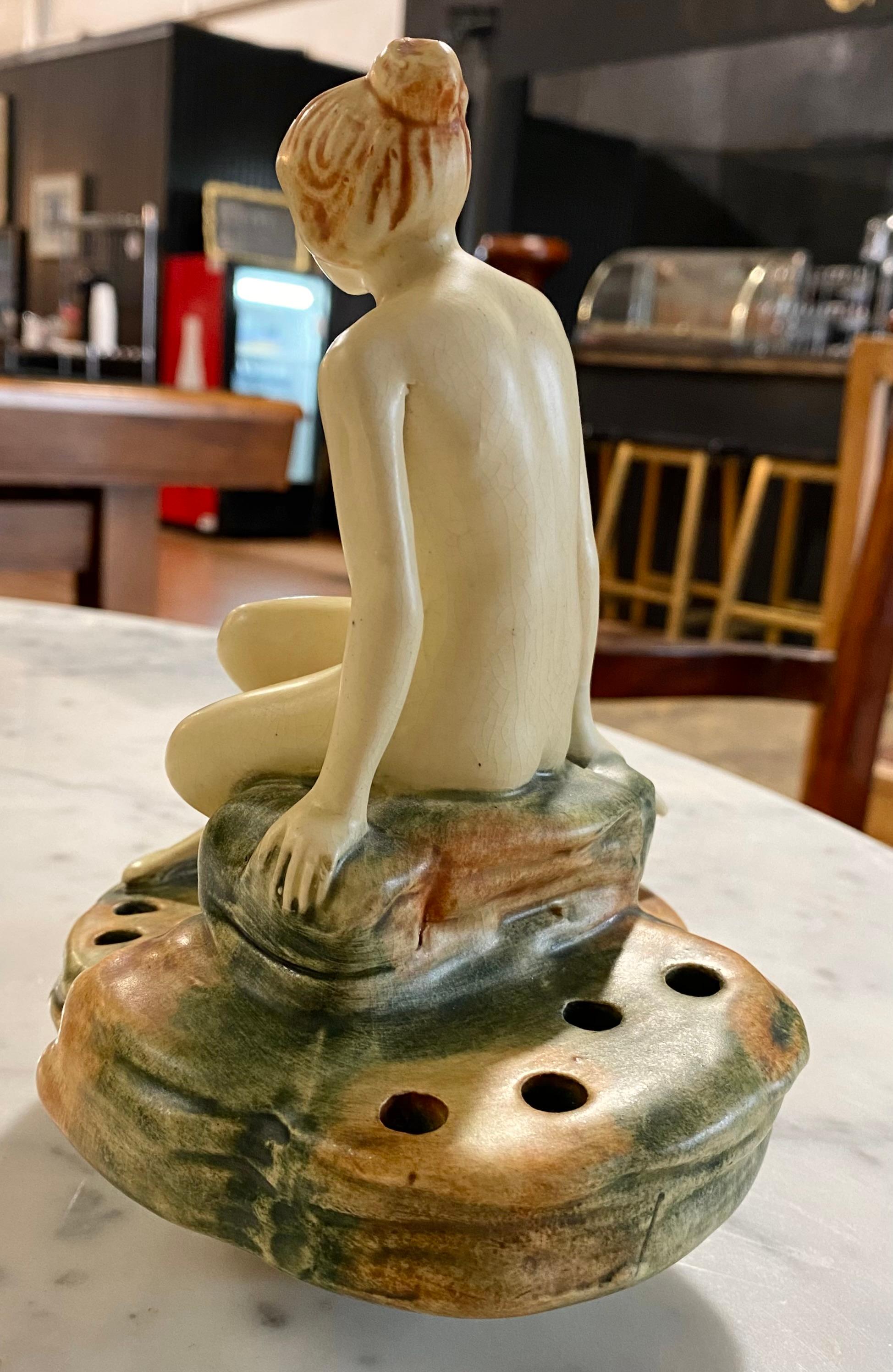 A spectacular 1920 Weller Art Nouveau seated nude woman, a swan and a flower frog. A lovely addition to enjoy for your collection. 

Weller Pottery is an Ohio-based company that was founded in 1872 by Samuel A. Weller. The company's products include