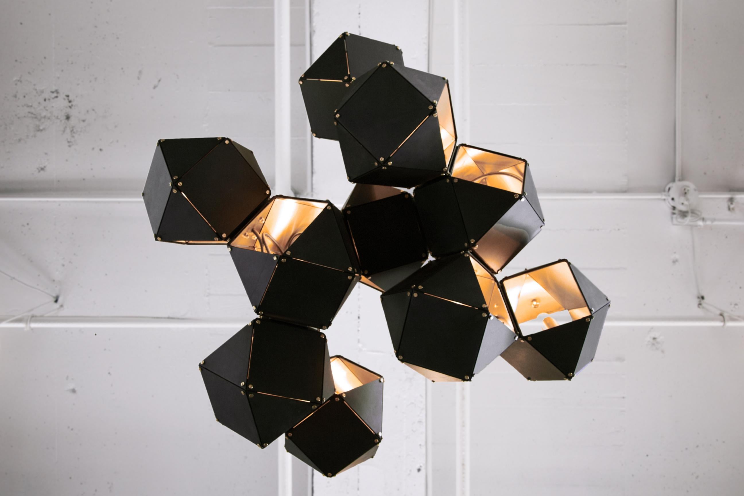 A fixture of metallic proportion, Gabriel Scott’s signature Welles is a modern piece that showcases expert artistry. Hollowed metallic polygons branch out into a modular system of interconnected configurations for a stunning optical illusion. With