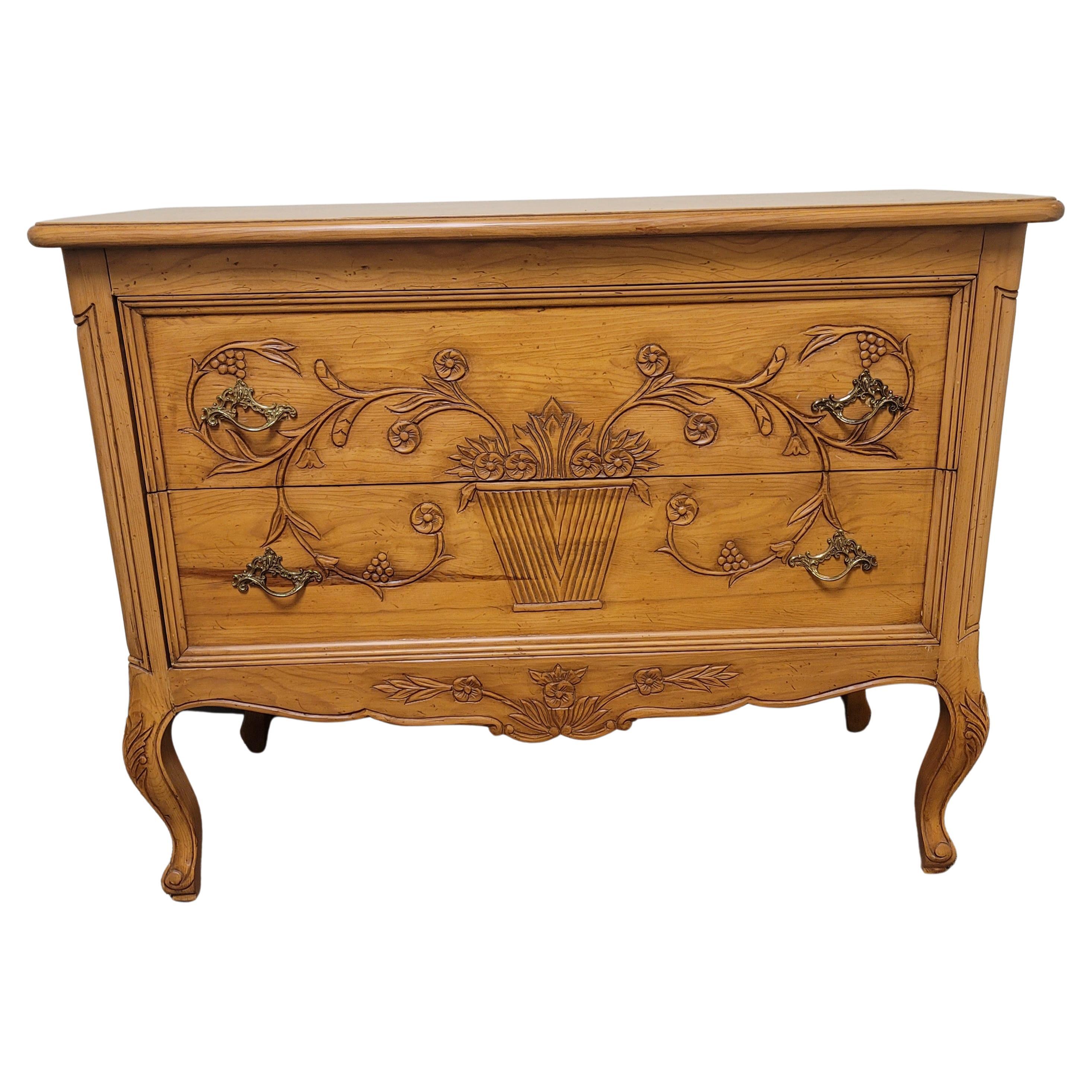 An exquisite, hand-carved hand-crafted arts and craft mixed with Provincial Style Fruitwood Commode by Wellesley Guild. Beautiful hand-carved flower bouquet in planter spands over the two drawers to create a rare visual effect of singularity and