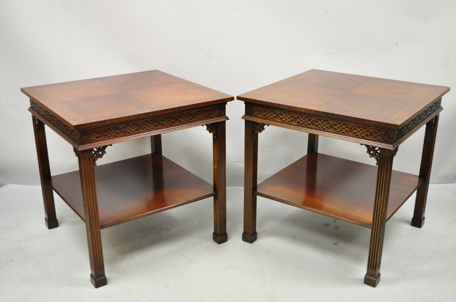 Wellington hall mahogany Chinese Chippendale fretwork end tables - a pair. Item features 2 tiers, banded tops, beautiful wood grain, nicely carved details, original label, quality American craftsmanship. Circa mid 20th century. Measurements: 26