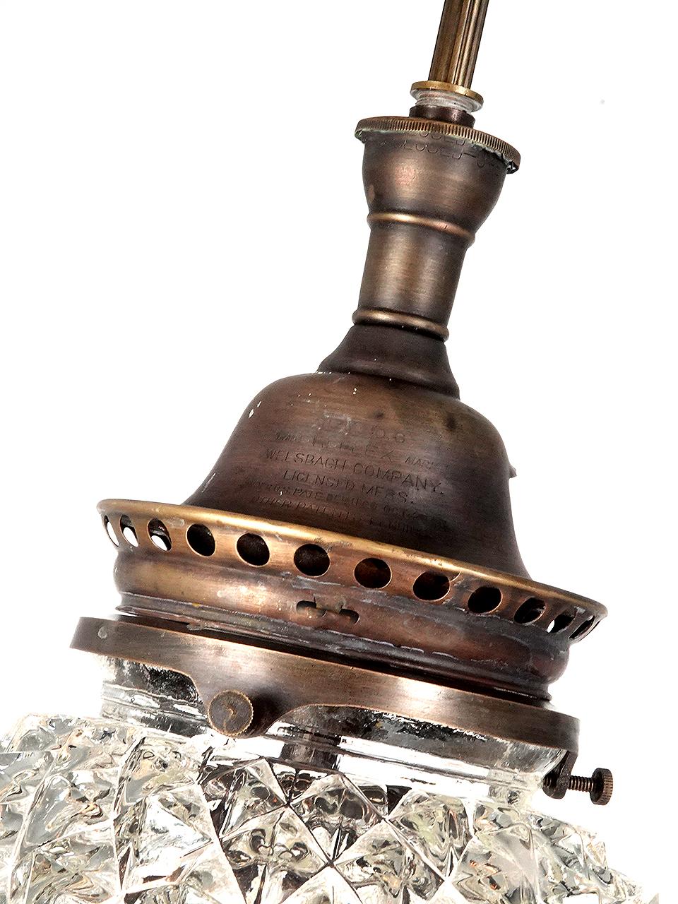 This is a small and very rich looking gem of a pendent. Its signed on the burner/shade holder Welsbach. It stands 16 inches tall plus whatever drop length you provide for finish. This is a thick and heavy 8 inch diameter globe. Its cast glass and