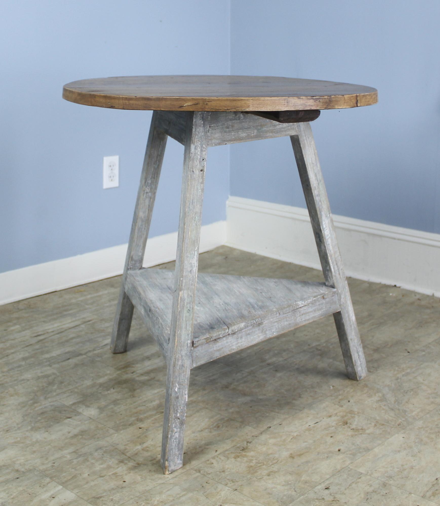 An antique Welsh cricket table. The base has been newly painted for a distressed look, and the top is a honey pine, both rich in wear and patina. Makes a terrific lamp table.
